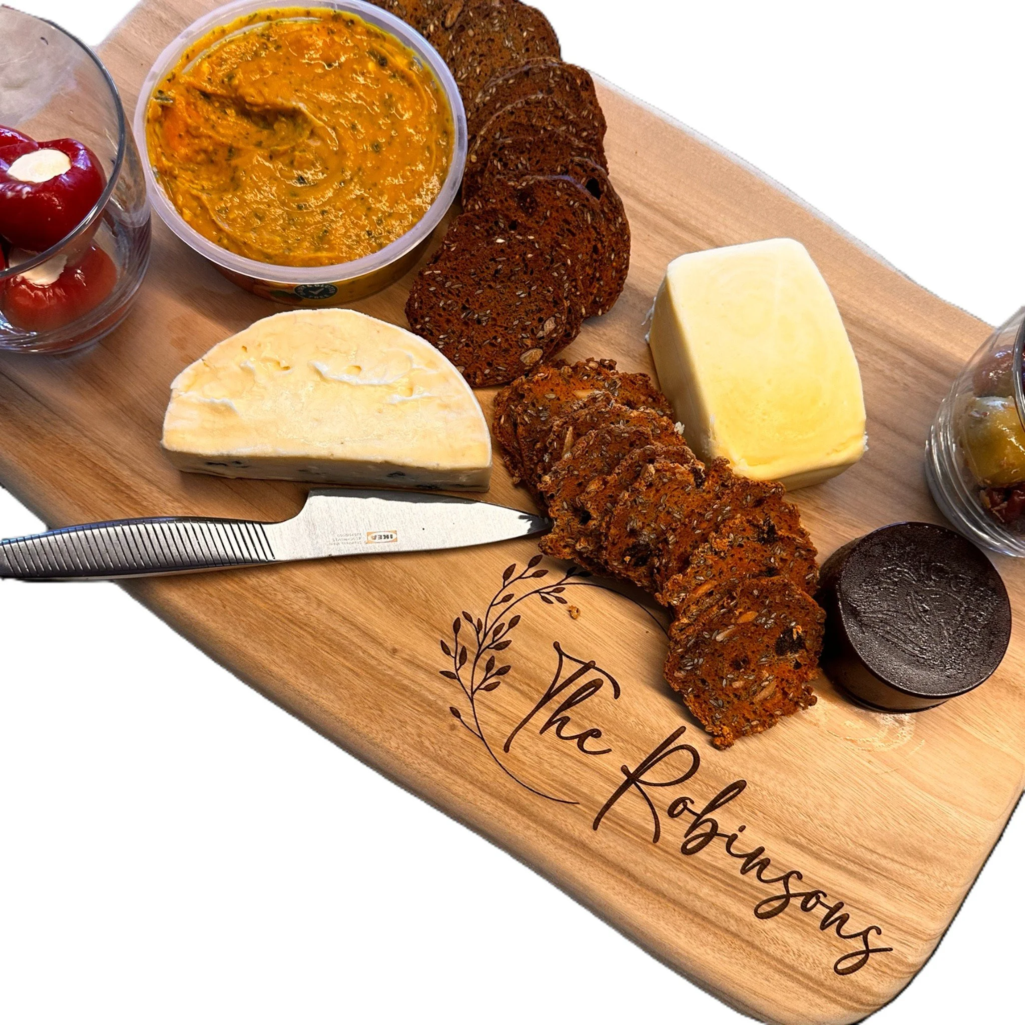 a styled large nibblies board with a personalised name The Robinsons in a decorative wreat,