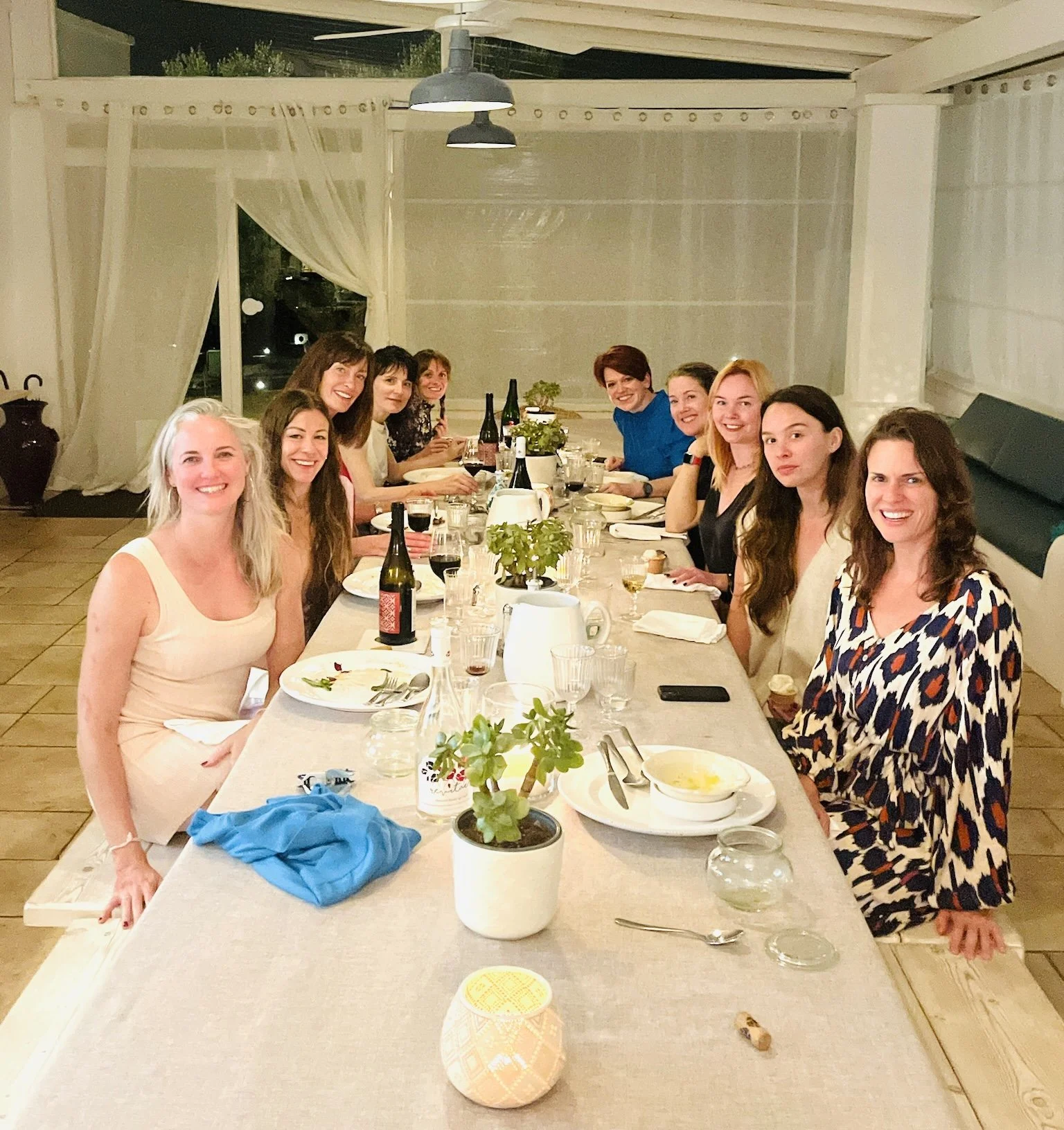 Women sharing dinner together during a retreat in Puglia, Italy
