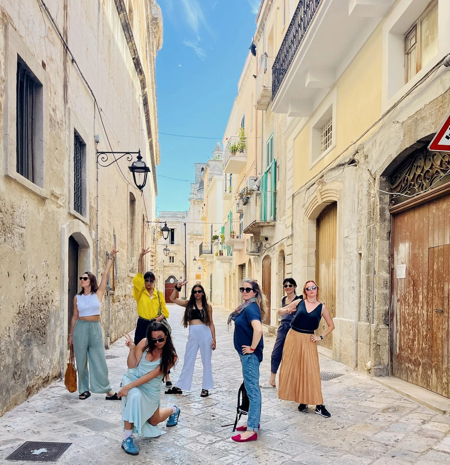 Women exploring the historic streets of Ostuni during a retreat in Puglia, Italy