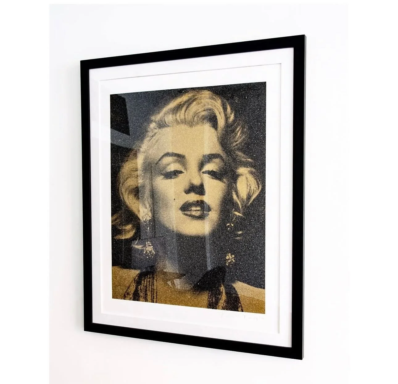 Russell Young&rsquo;s &ldquo;Marilyn Portrait&rdquo; integrates a material known as &ldquo;Diamond Dust&rdquo; that creates a glittery luster on the surface of the piece.
The work, which is framed and matted, is an edition of 50 and hand signed by th