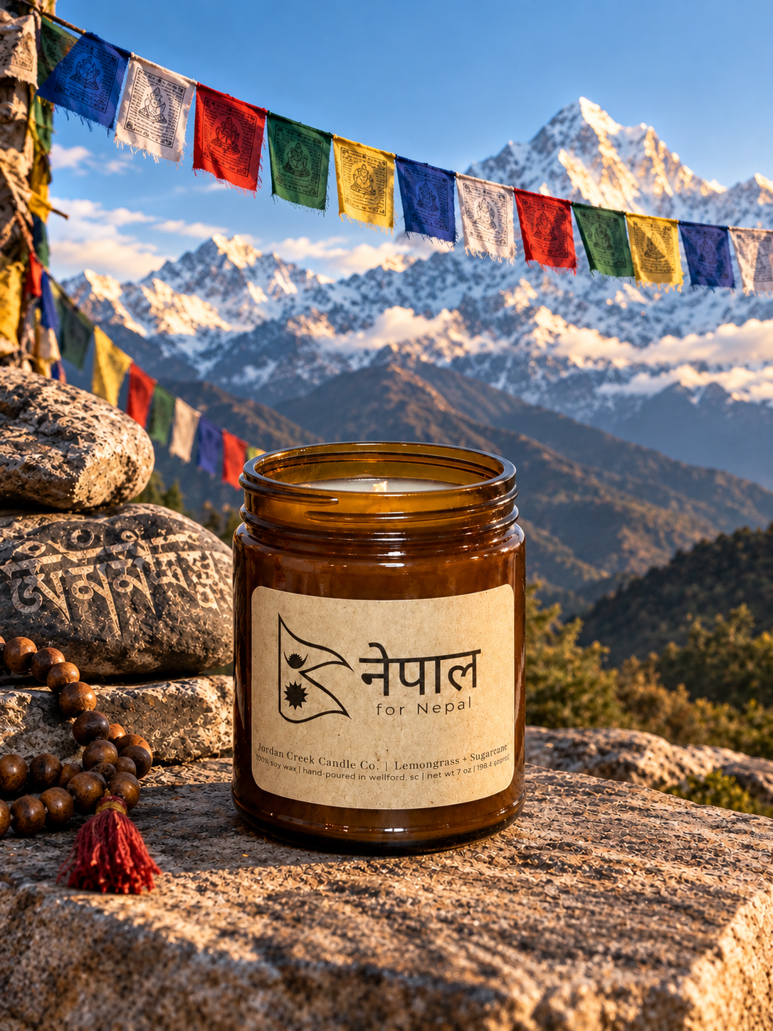 For Nepal candle sitting in from of mountains with colorful flags