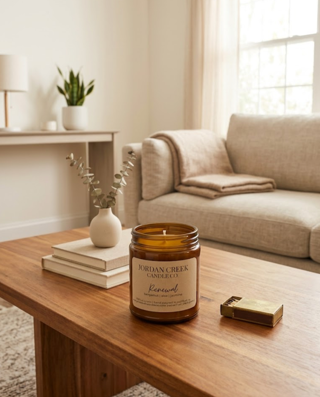 Renewal Candle sitting on top of a coffee table