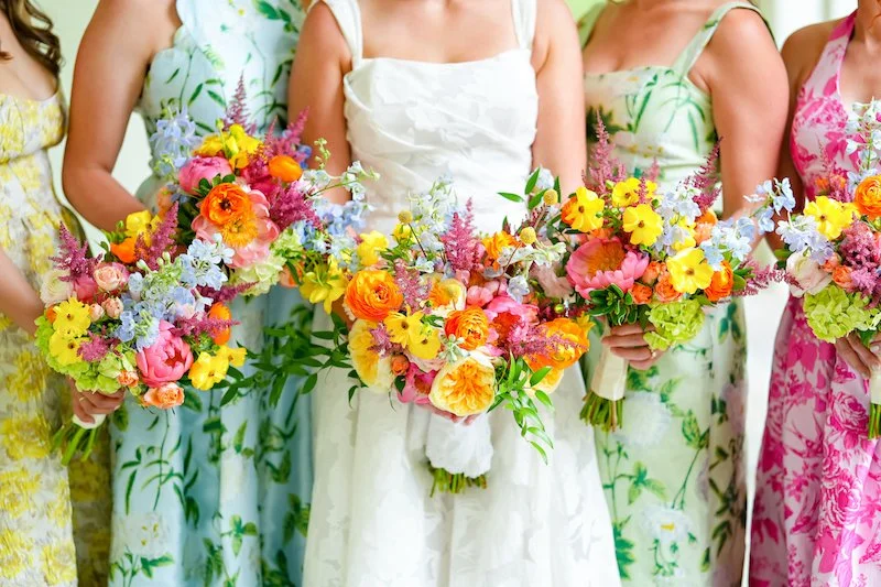 Bridesmaids holding vibrant bouquets showcasing wedding color palettes