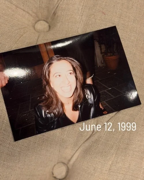 A photo of a woman in her 20s or 30s, smiliing.