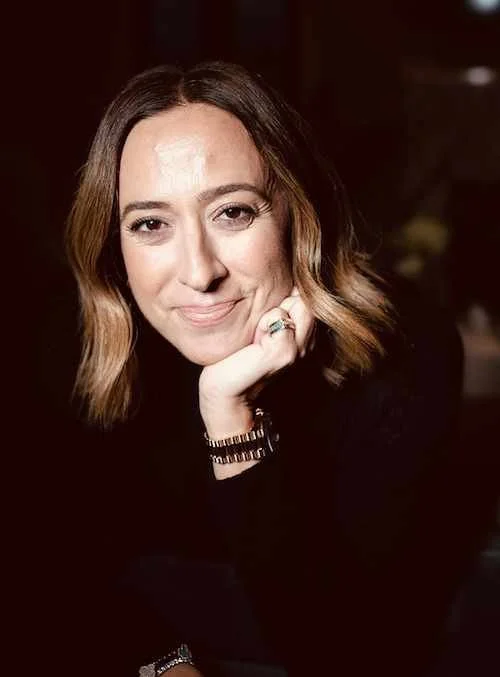Portrait headshot of a woman looking straight and smiling