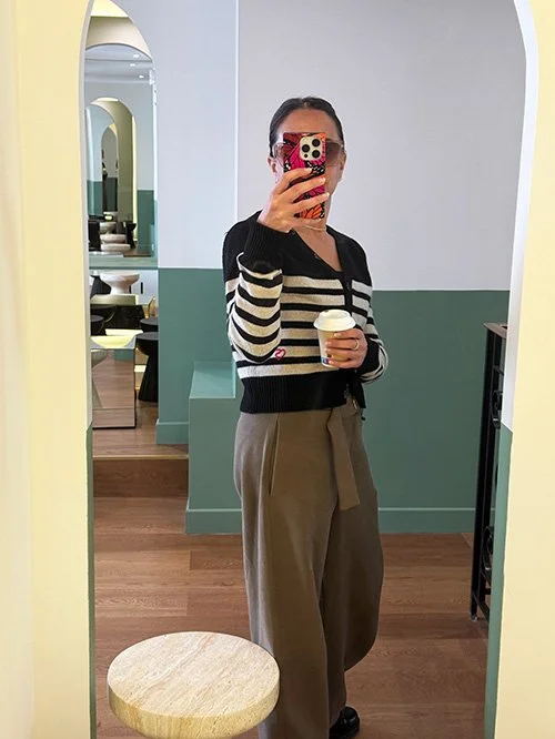 Woman holding coffee cup in morning routine representing daily commitment to goals and habits