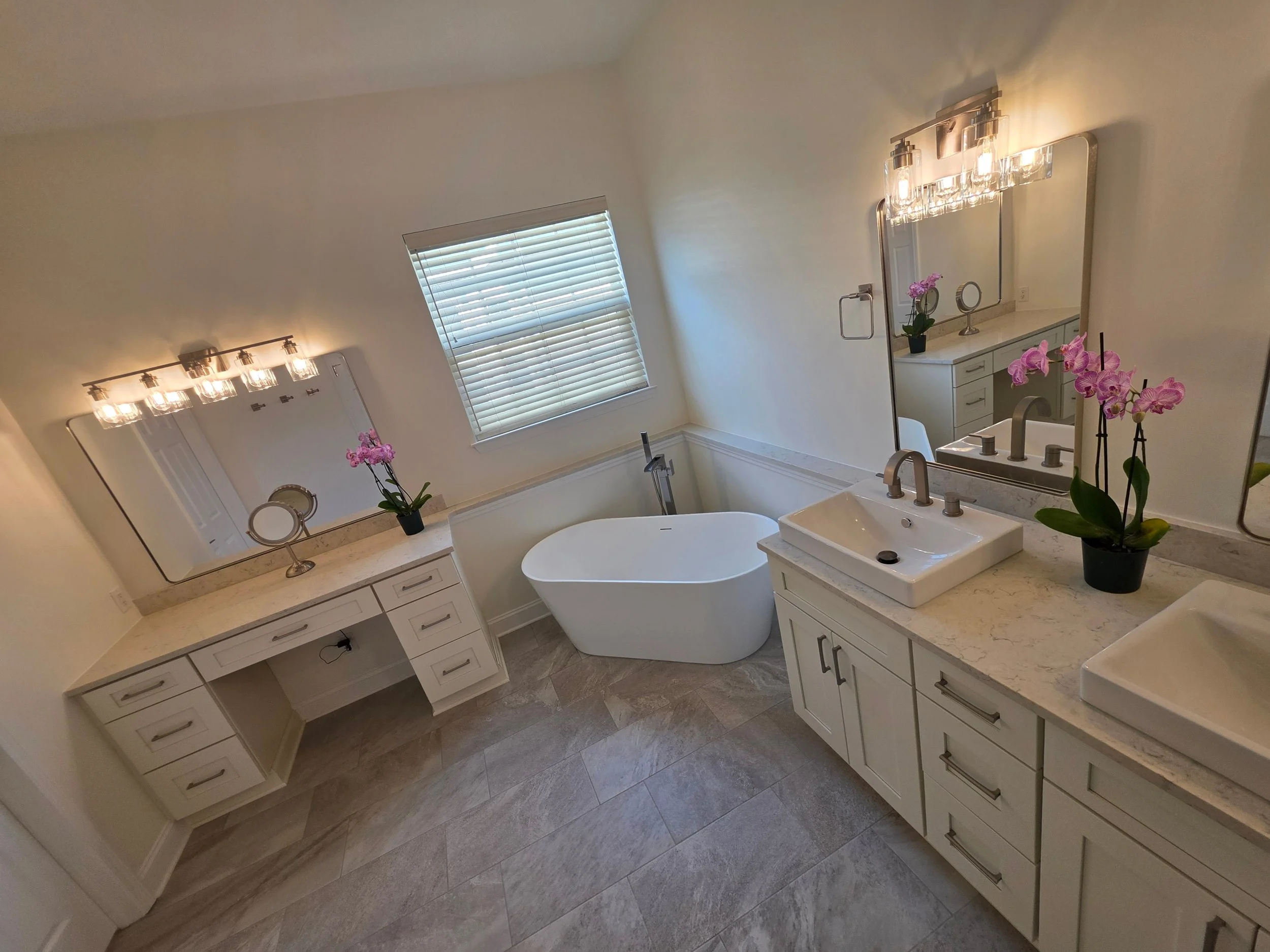 Sheila’s master bathroom with freestanding tub and light vanity cabinets.