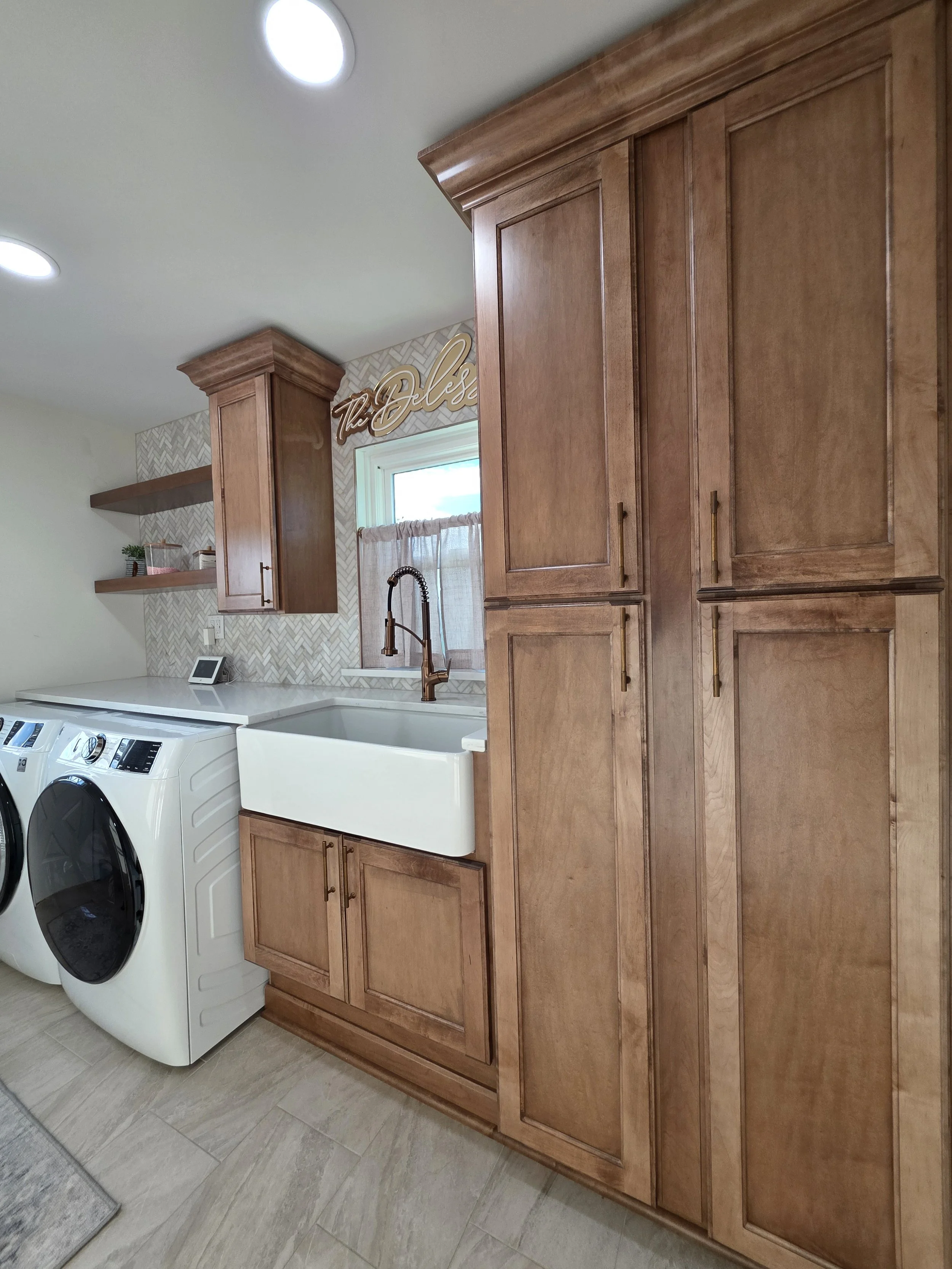 Close view of the tall laundry-room cabinets and farmhouse sink.
