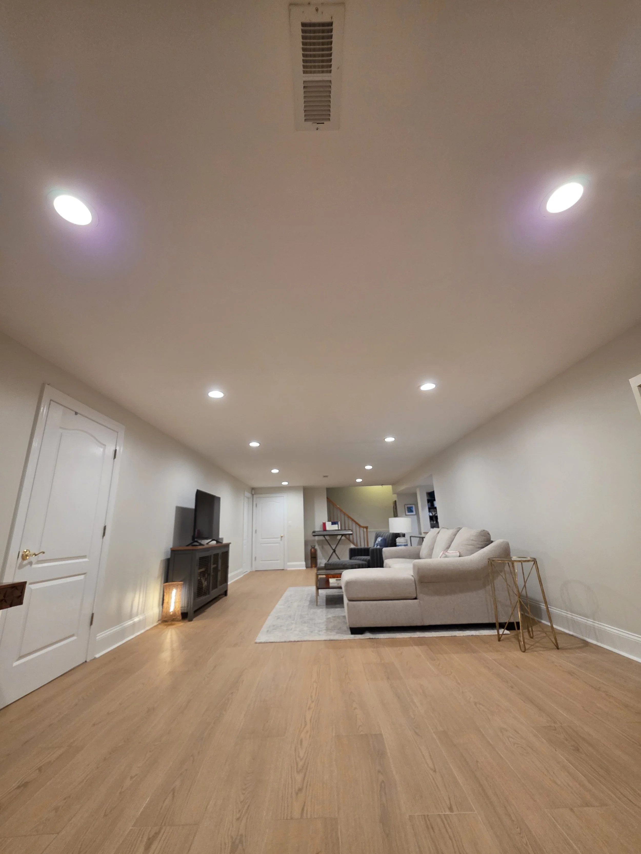 Long view across newly tiled basement floor.