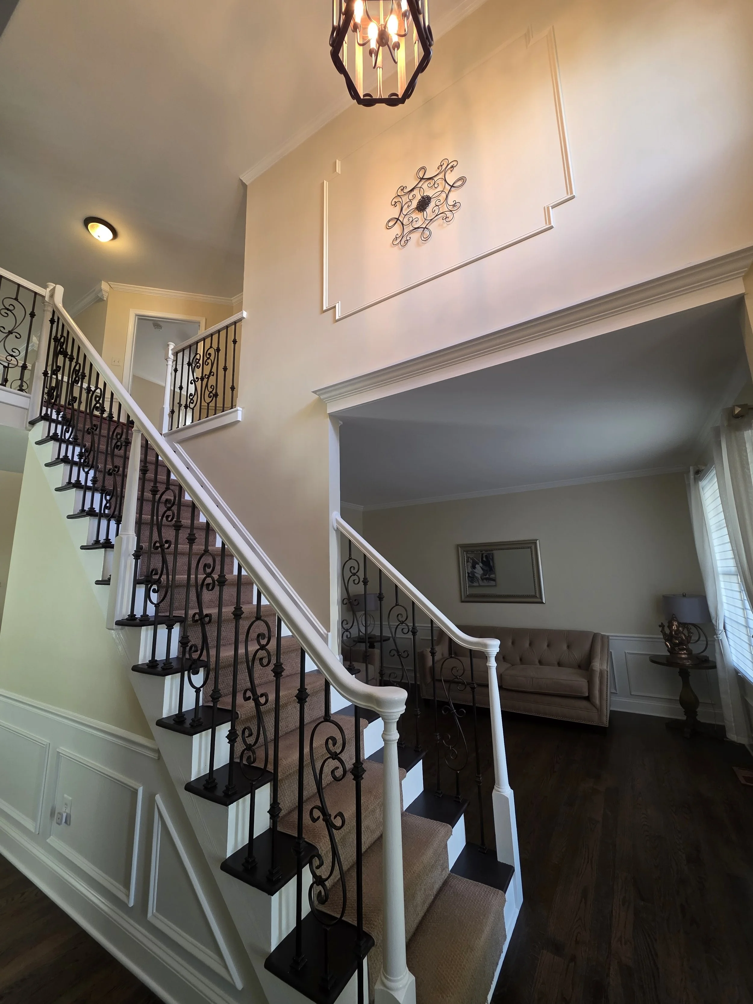 Painted entry and staircase walls with decorative trim.