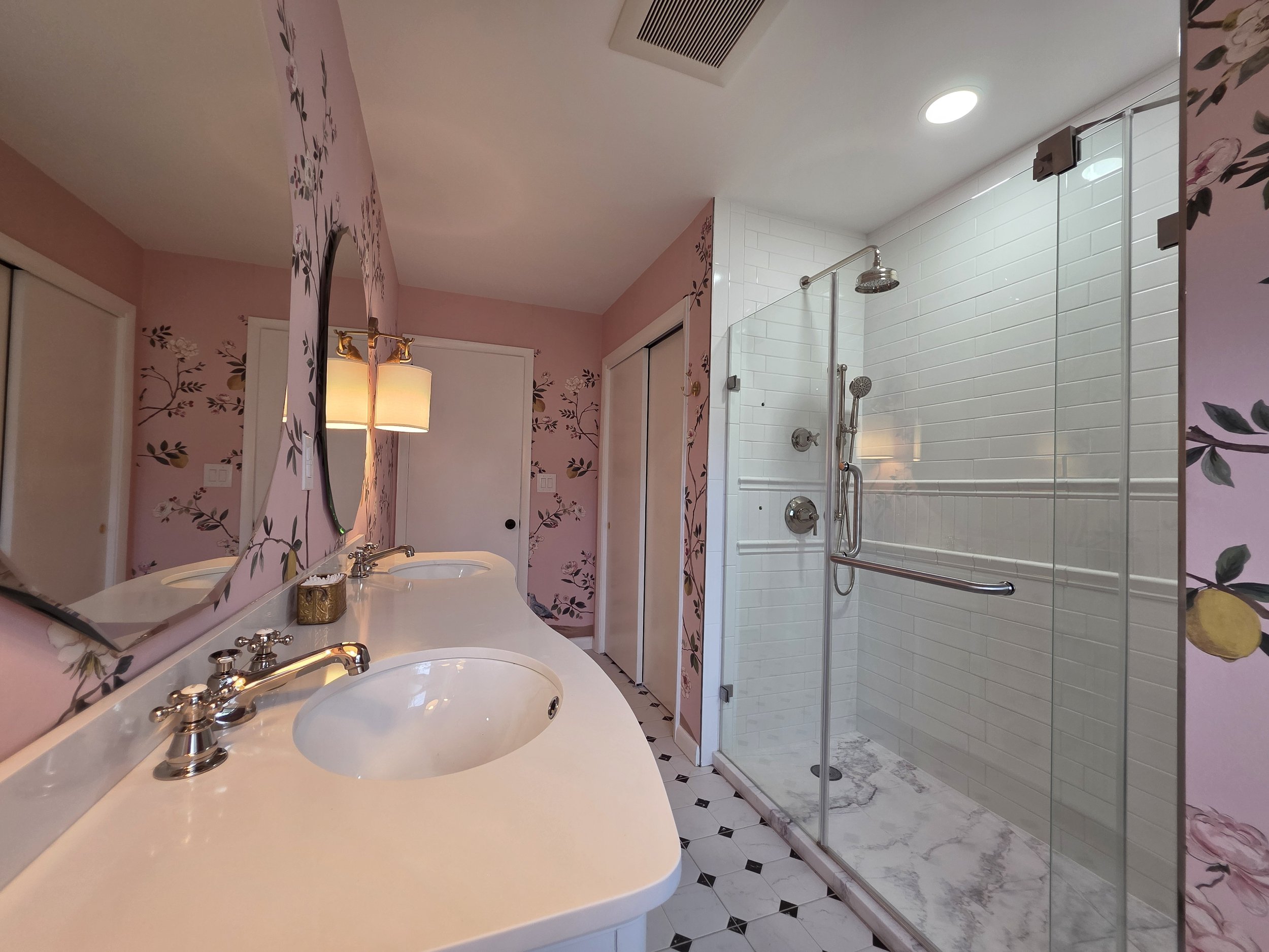 Double sink countertop facing the glass shower.