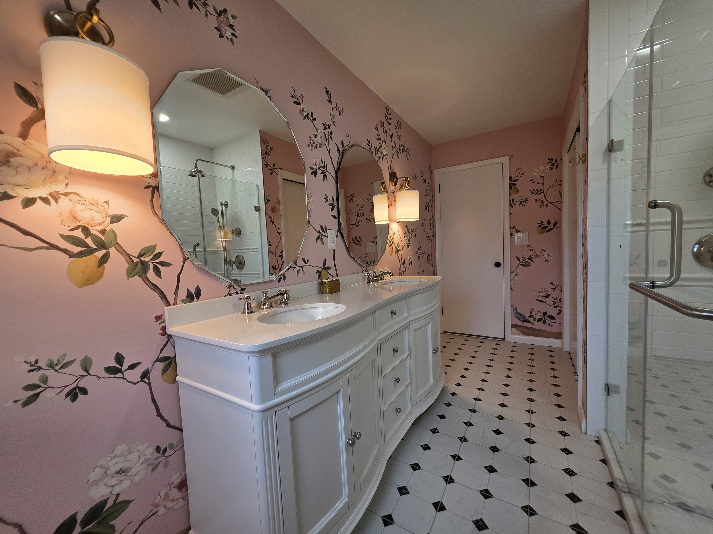 Bevin and TJ’s hallway bathroom with white double vanity and pink botanical wallpaper.