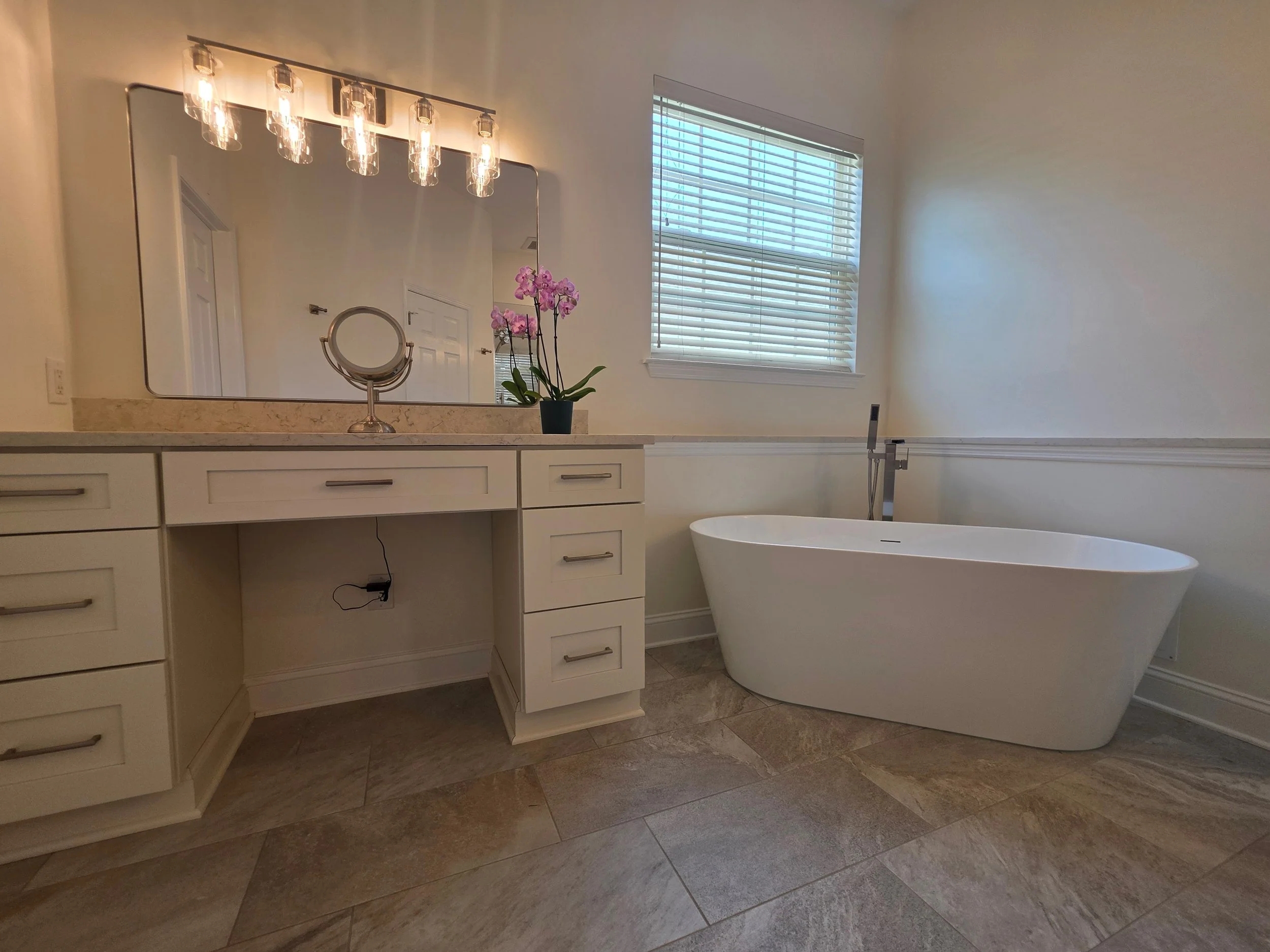 Vanity dressing area and freestanding bathtub.