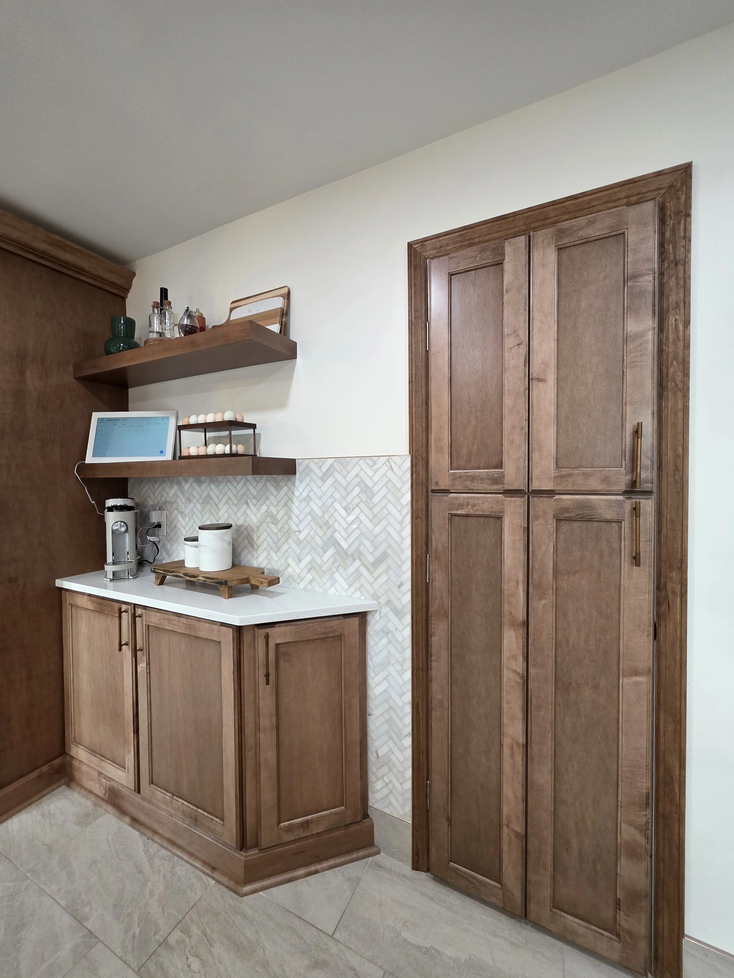 Coffee station with floating wood shelves and a matching wood door.