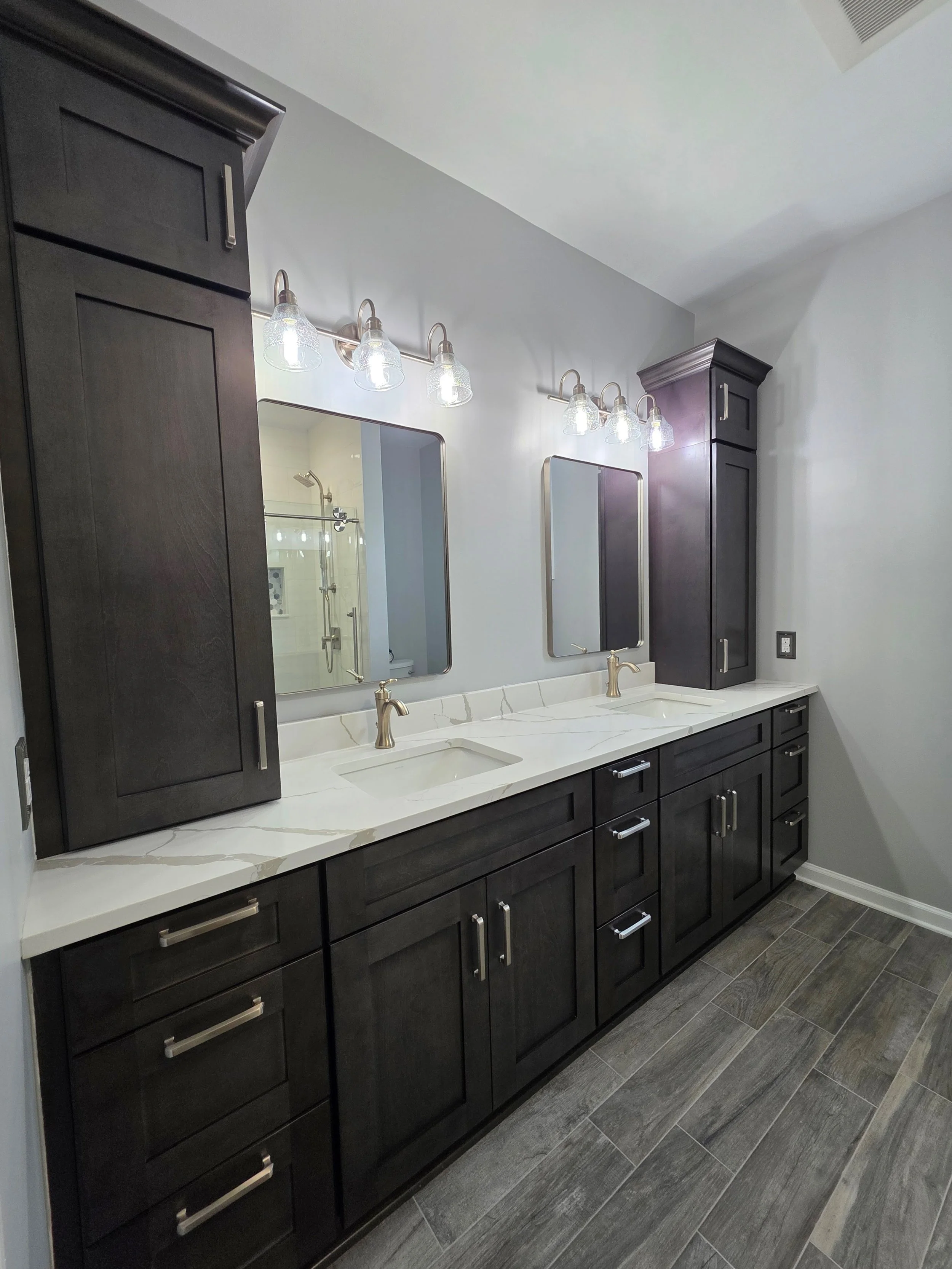 Cindy and Dave’s double vanity with dark cabinetry and light countertop.