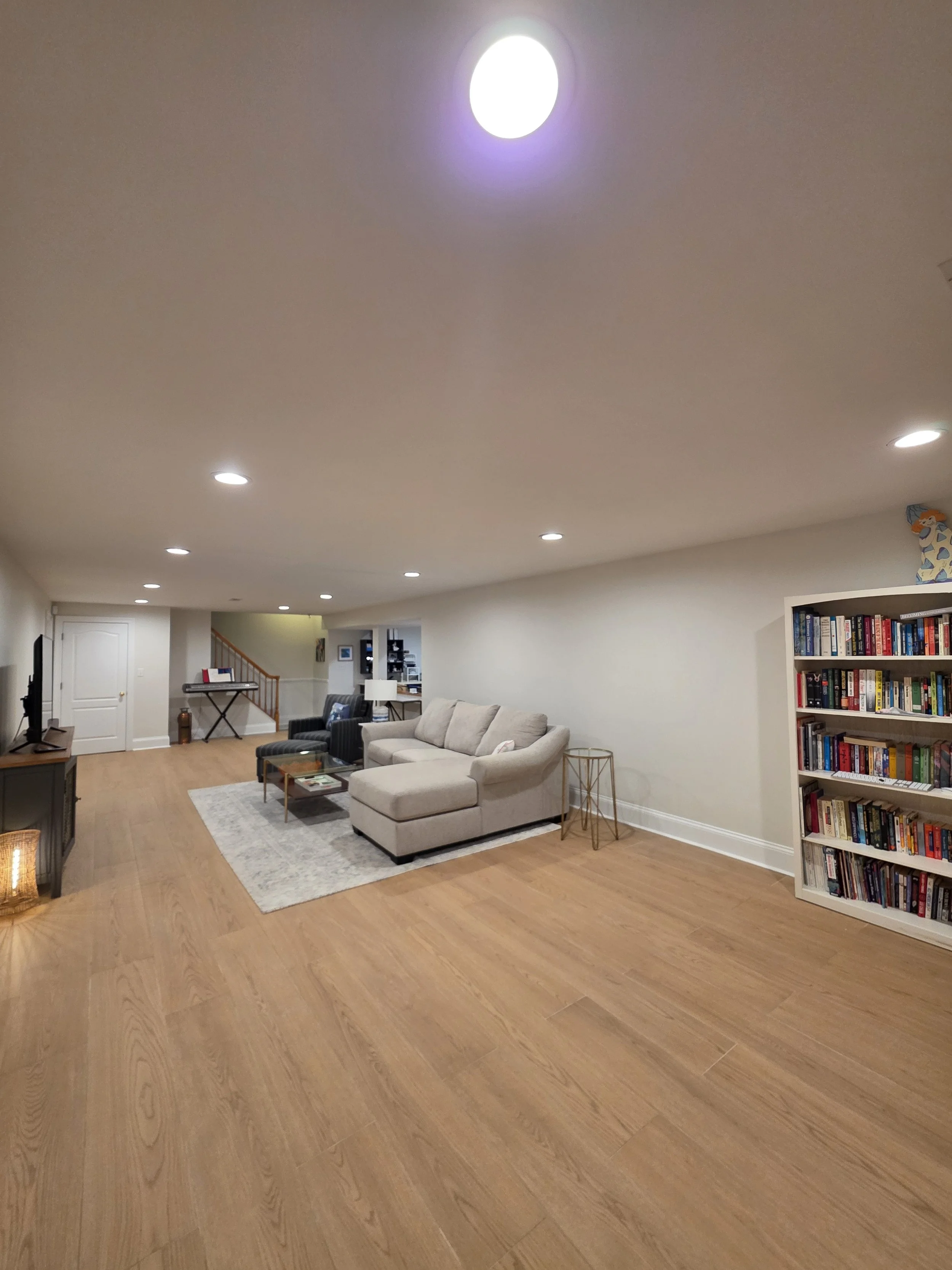 Karen and Ed’s basement living area with new wood-look tile flooring.