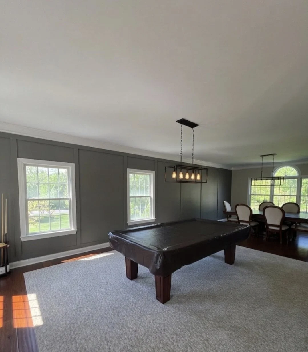 Alan and Alissa’s refreshed dining and game room with dark board-and-batten trim, new lighting and painted walls.