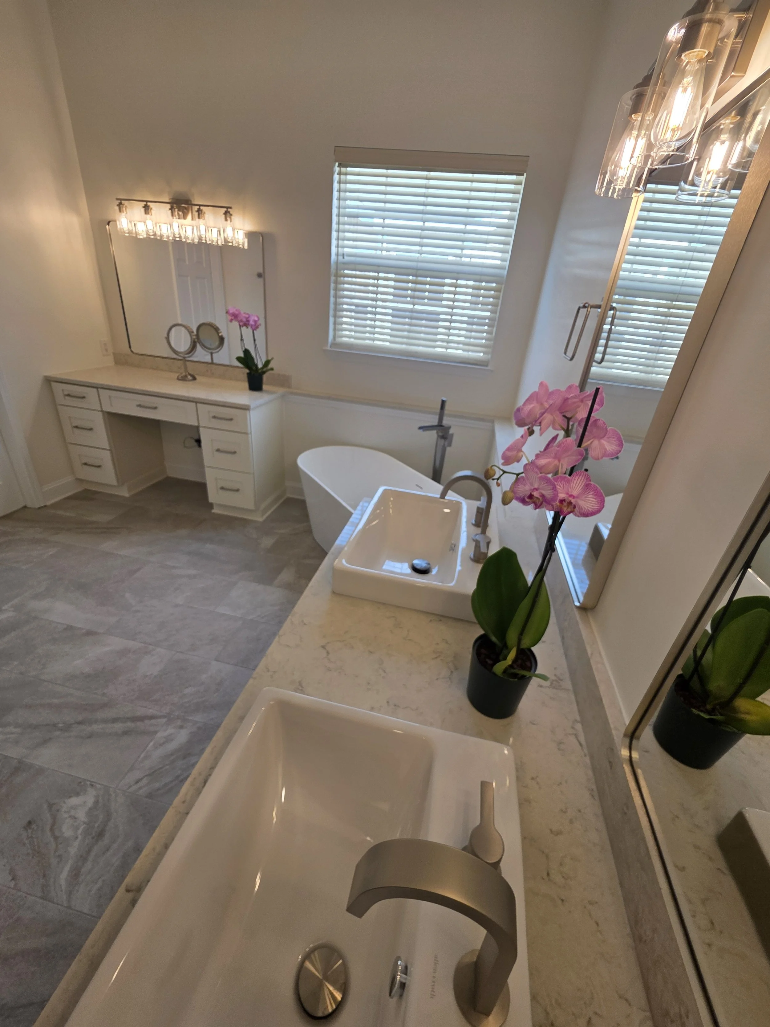 Bathroom view across vanity countertop toward the tub.
