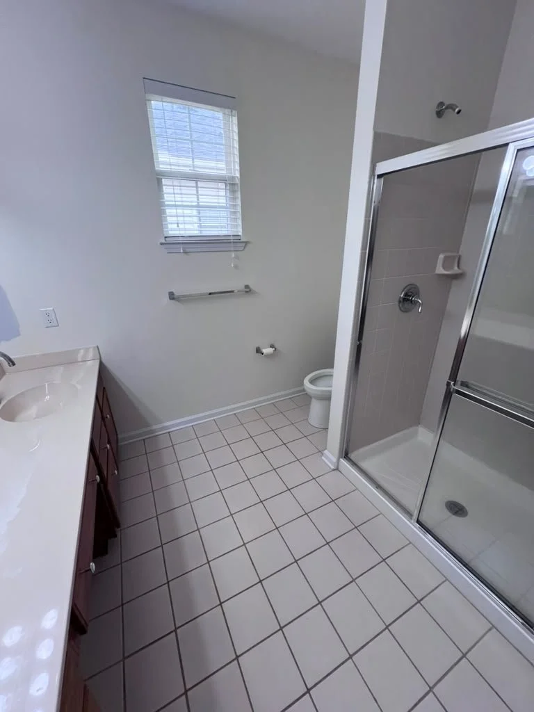 Master bathroom before renovation with older shower enclosure.