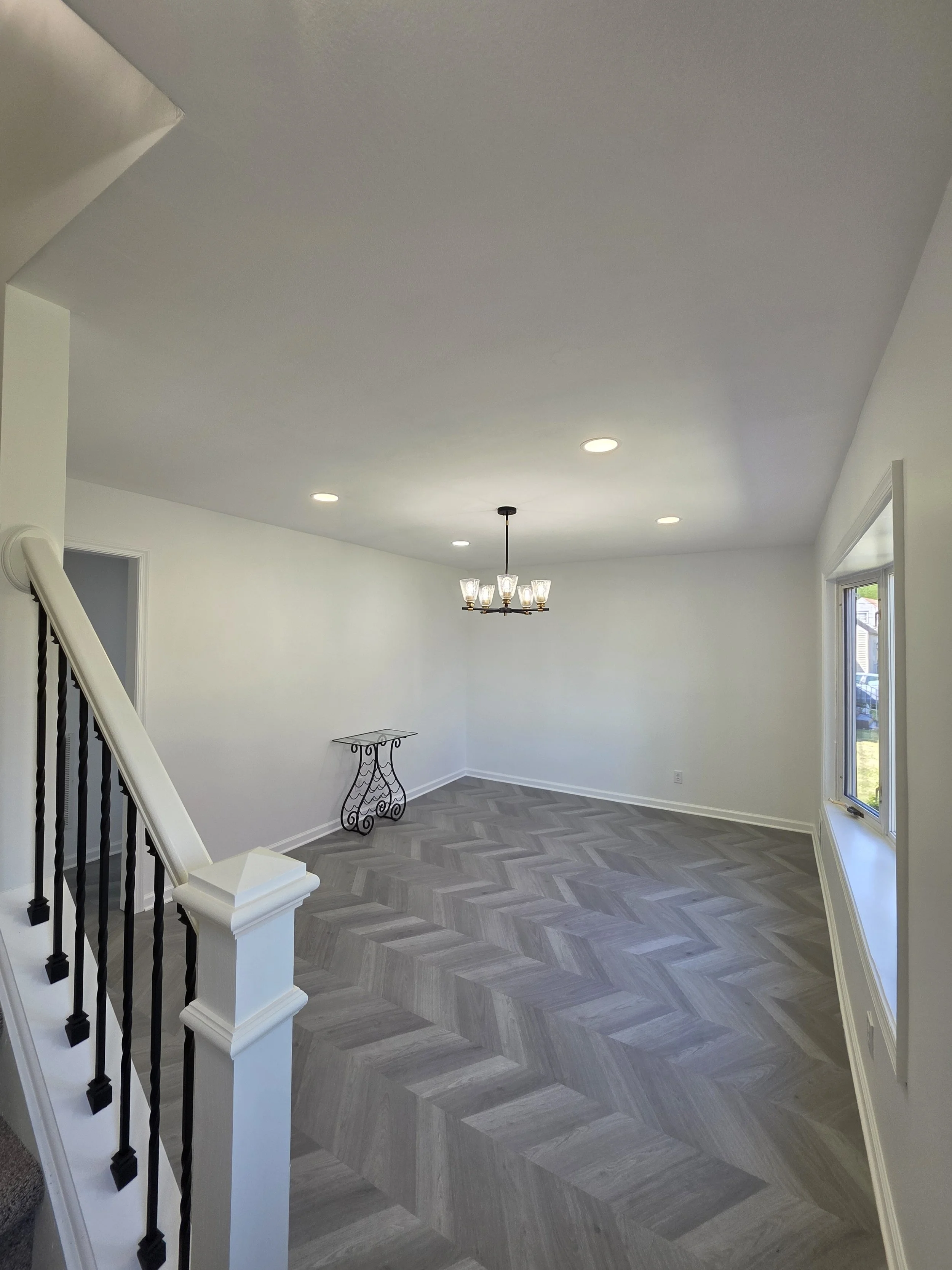 View from the staircase into the dining room and newly finished flooring.