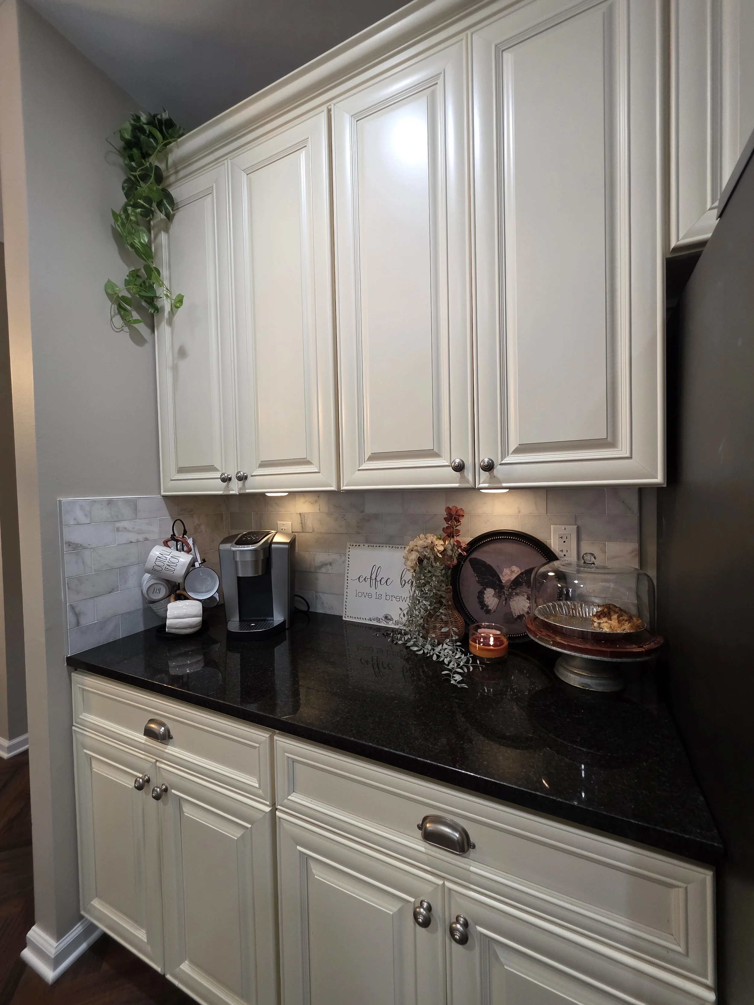 New backsplash beneath existing white cabinetry.
