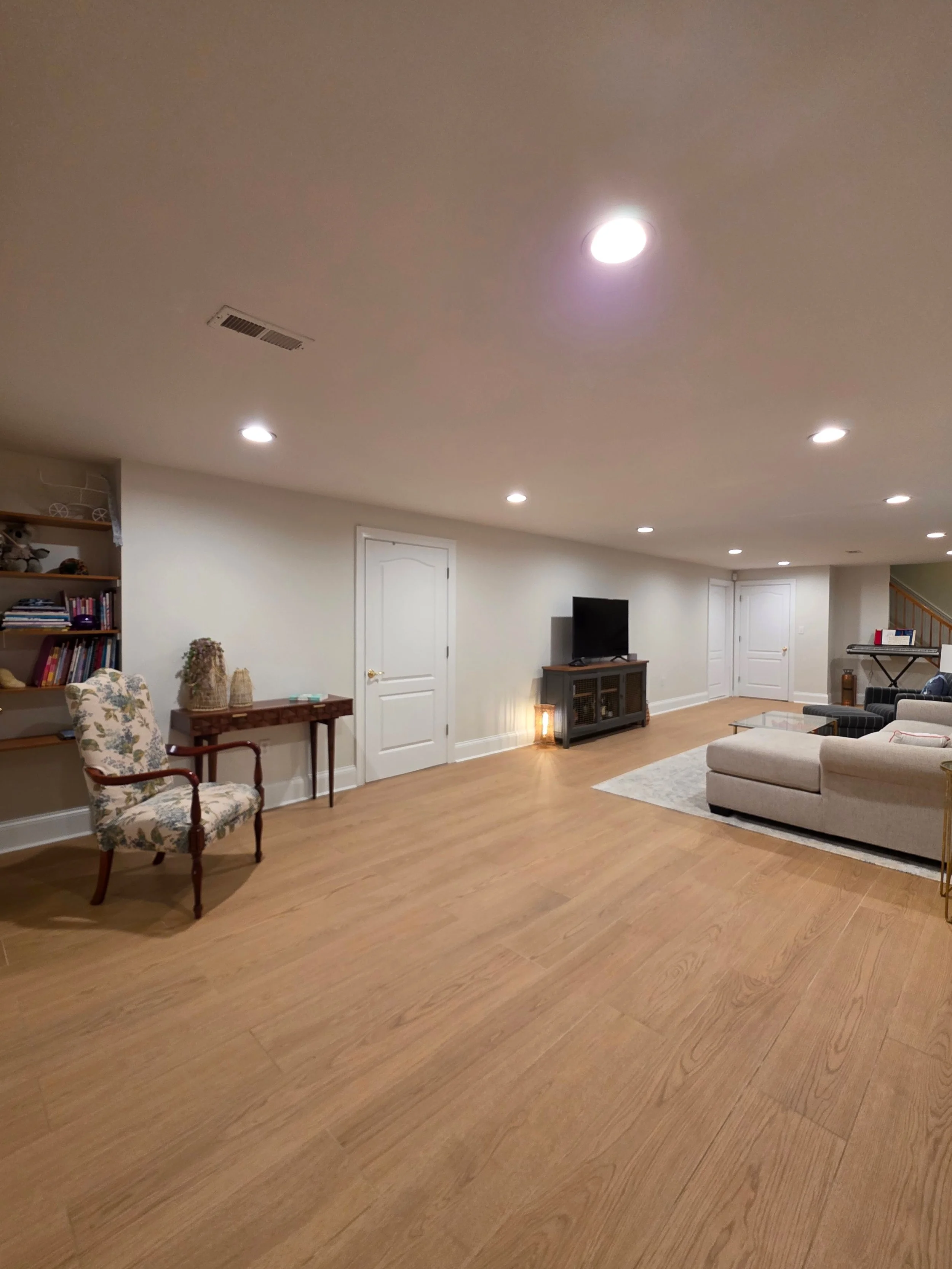 Basement floor extending from seating area to storage doors.
