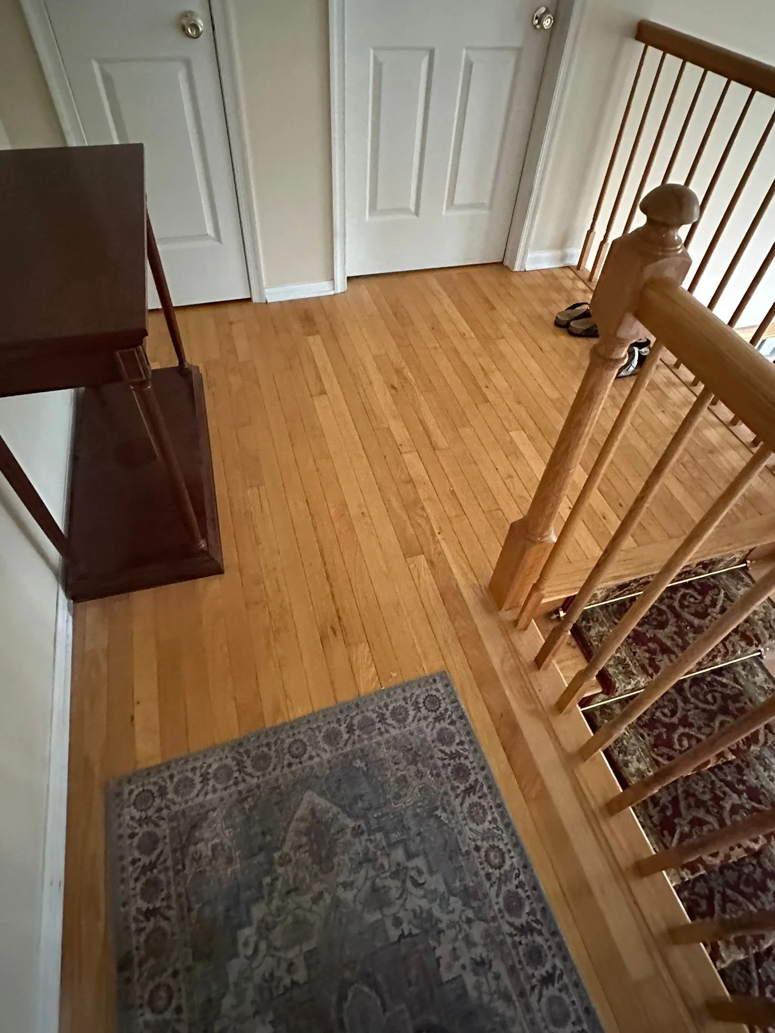 Before renovation: the upstairs hallway and original wood balusters.