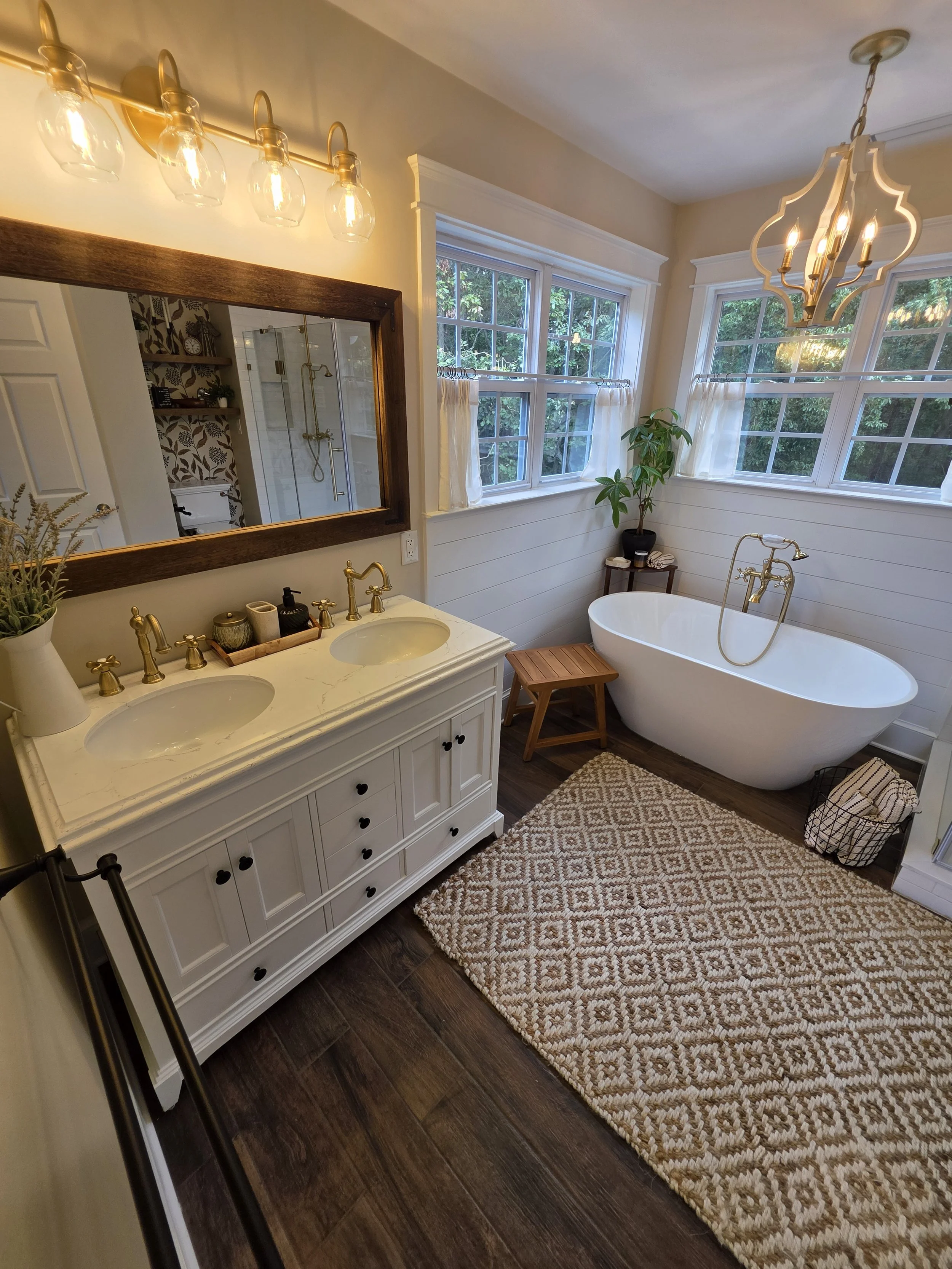 Master bathroom vanity, chandelier and freestanding tub.