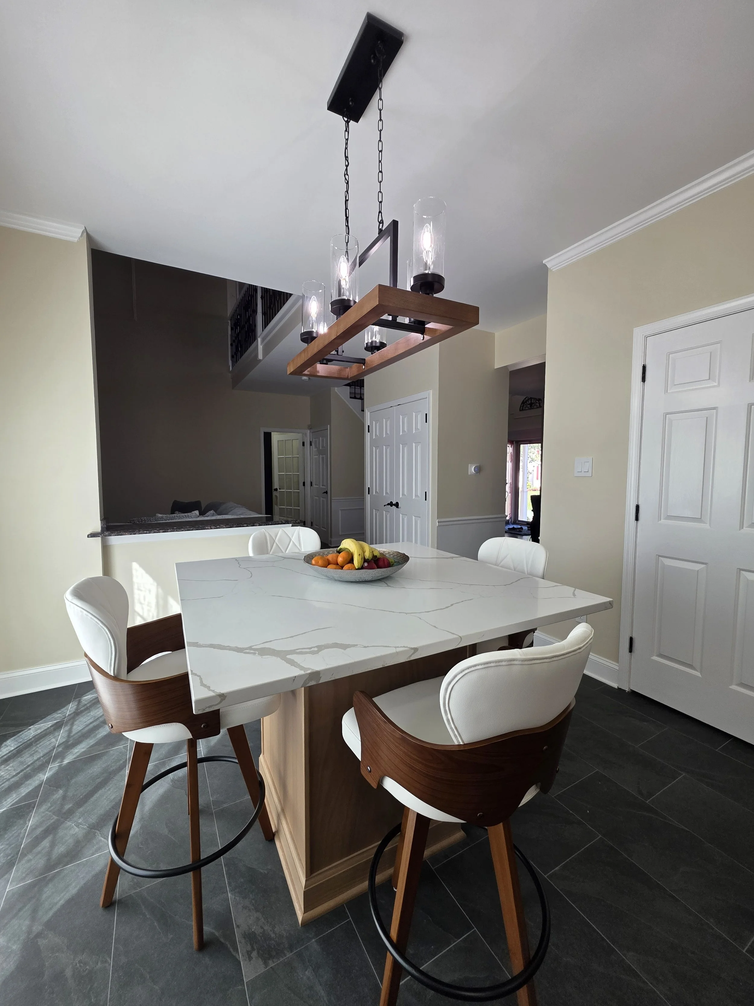 Kitchen island dining area with upholstered stools.