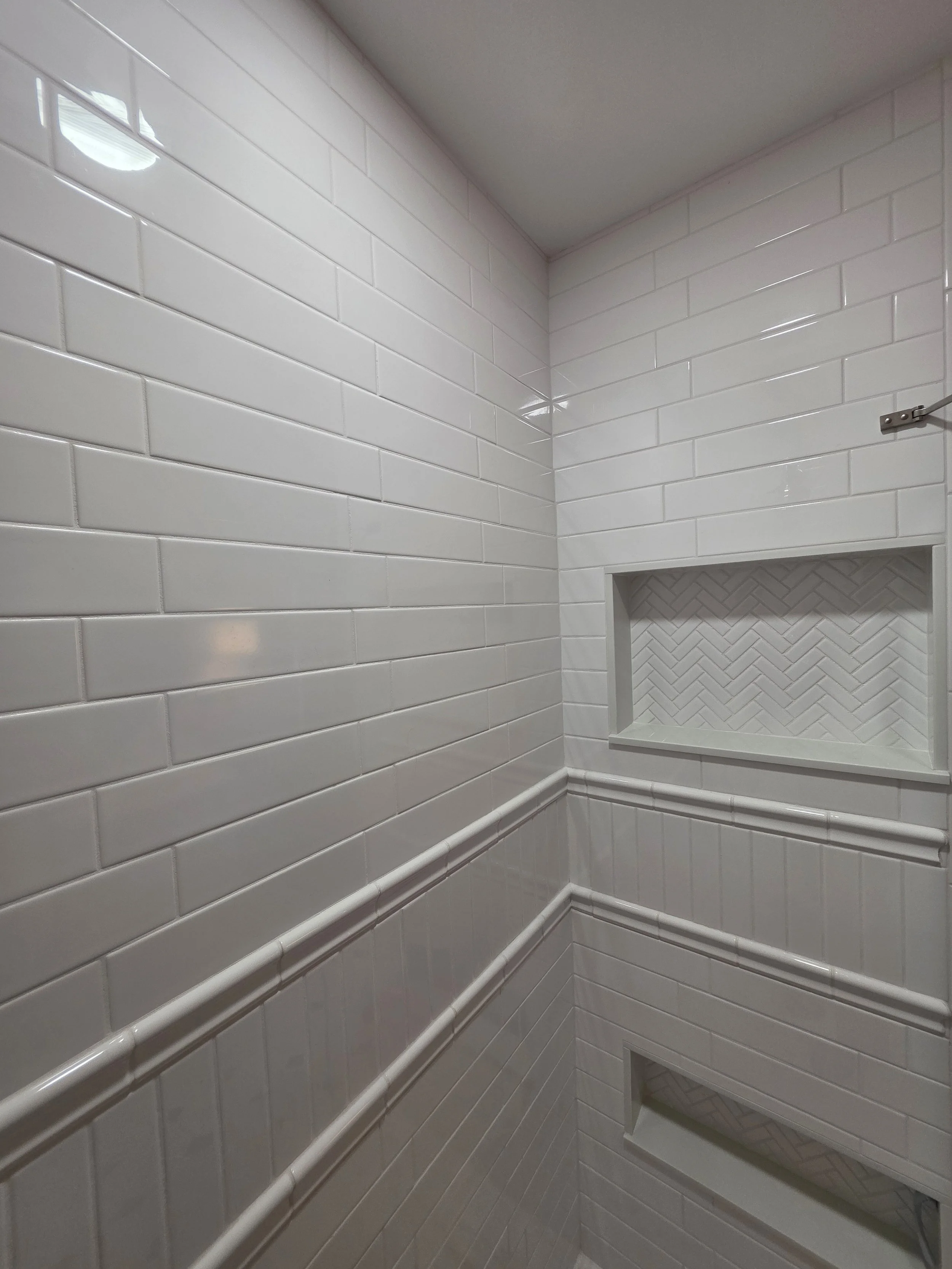Shower niche and decorative wall paneling.