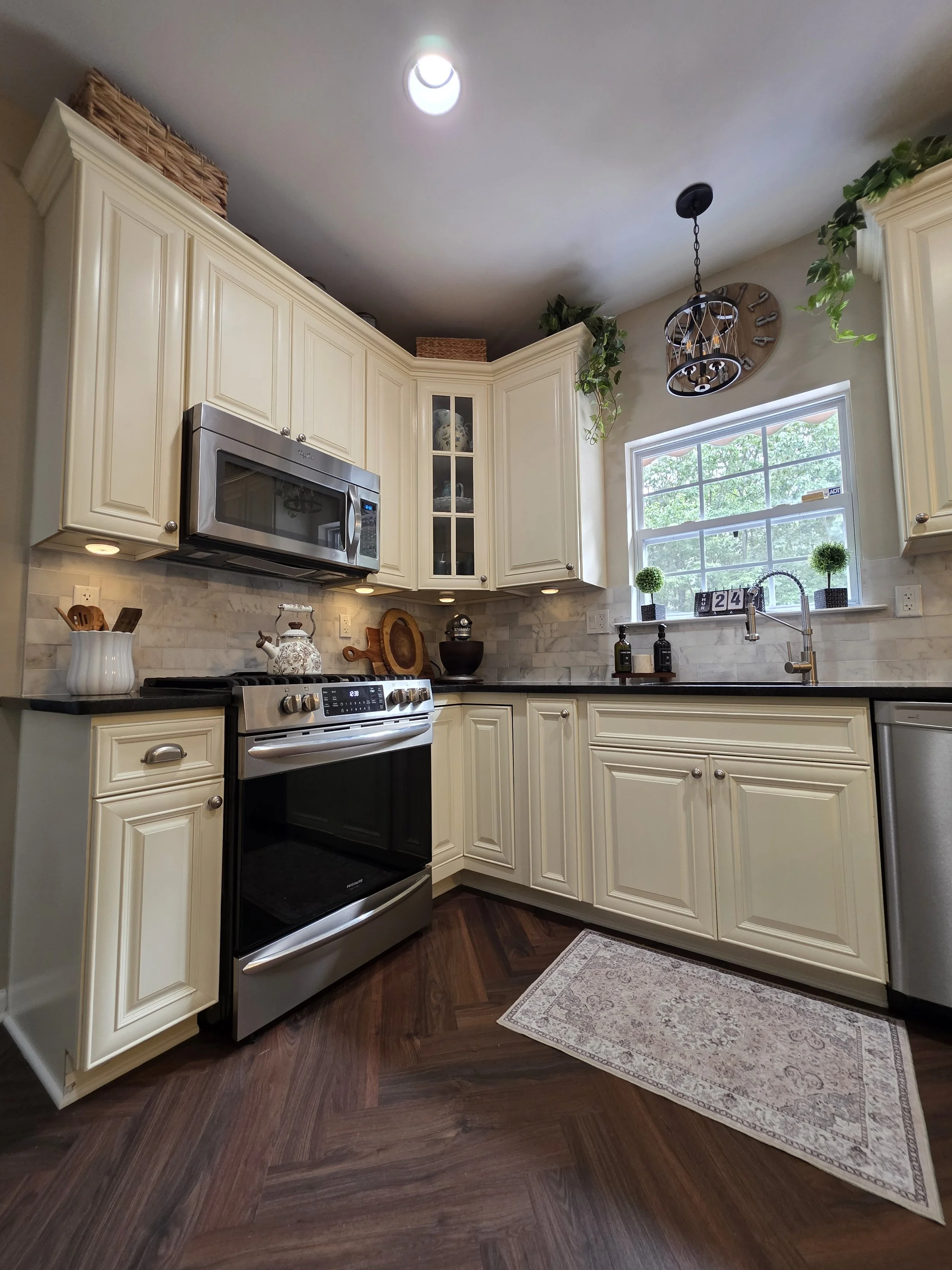 Backsplash and flooring at the range and sink corner.
