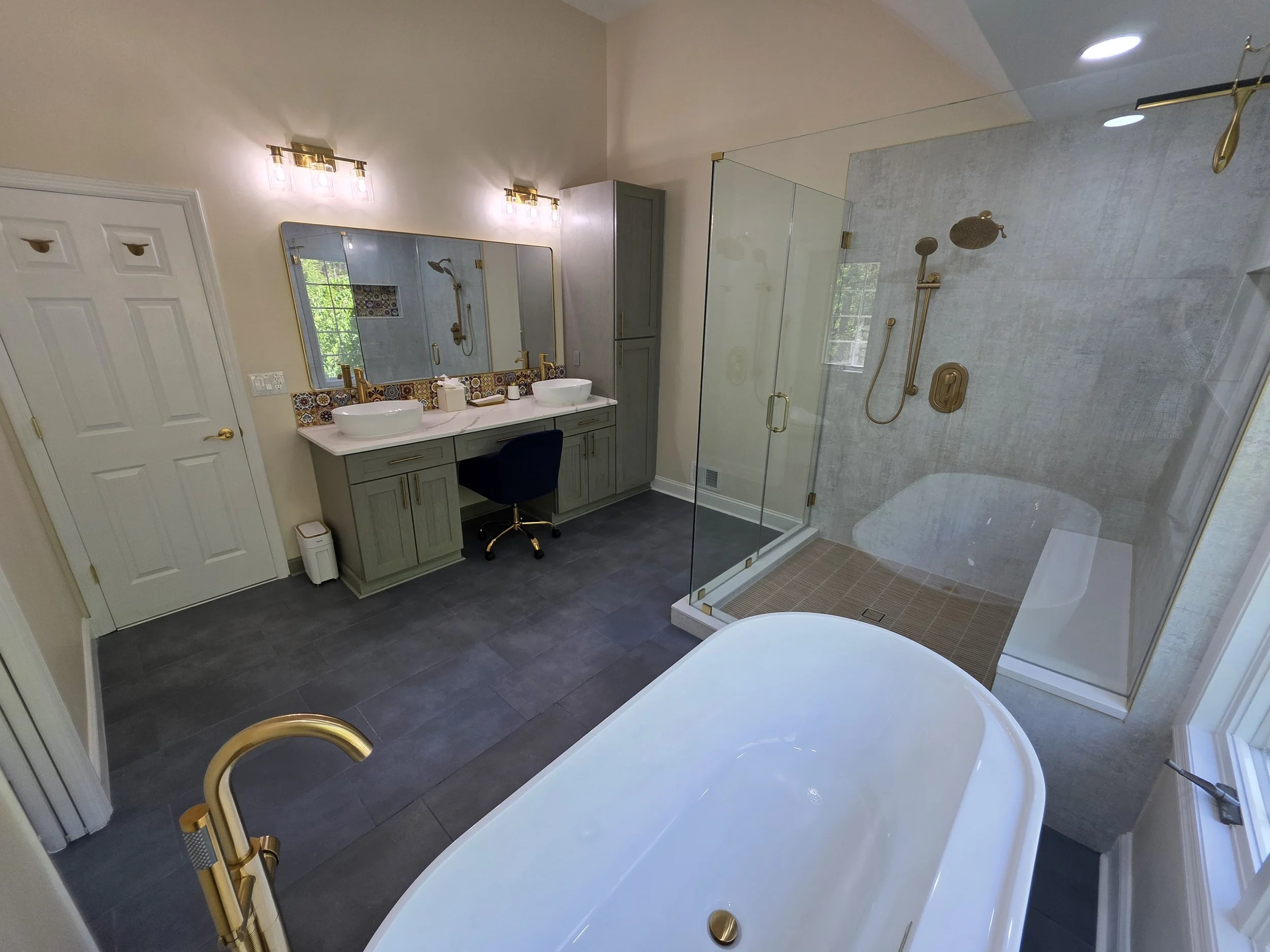 View from the freestanding tub toward the double vanity and glass shower.