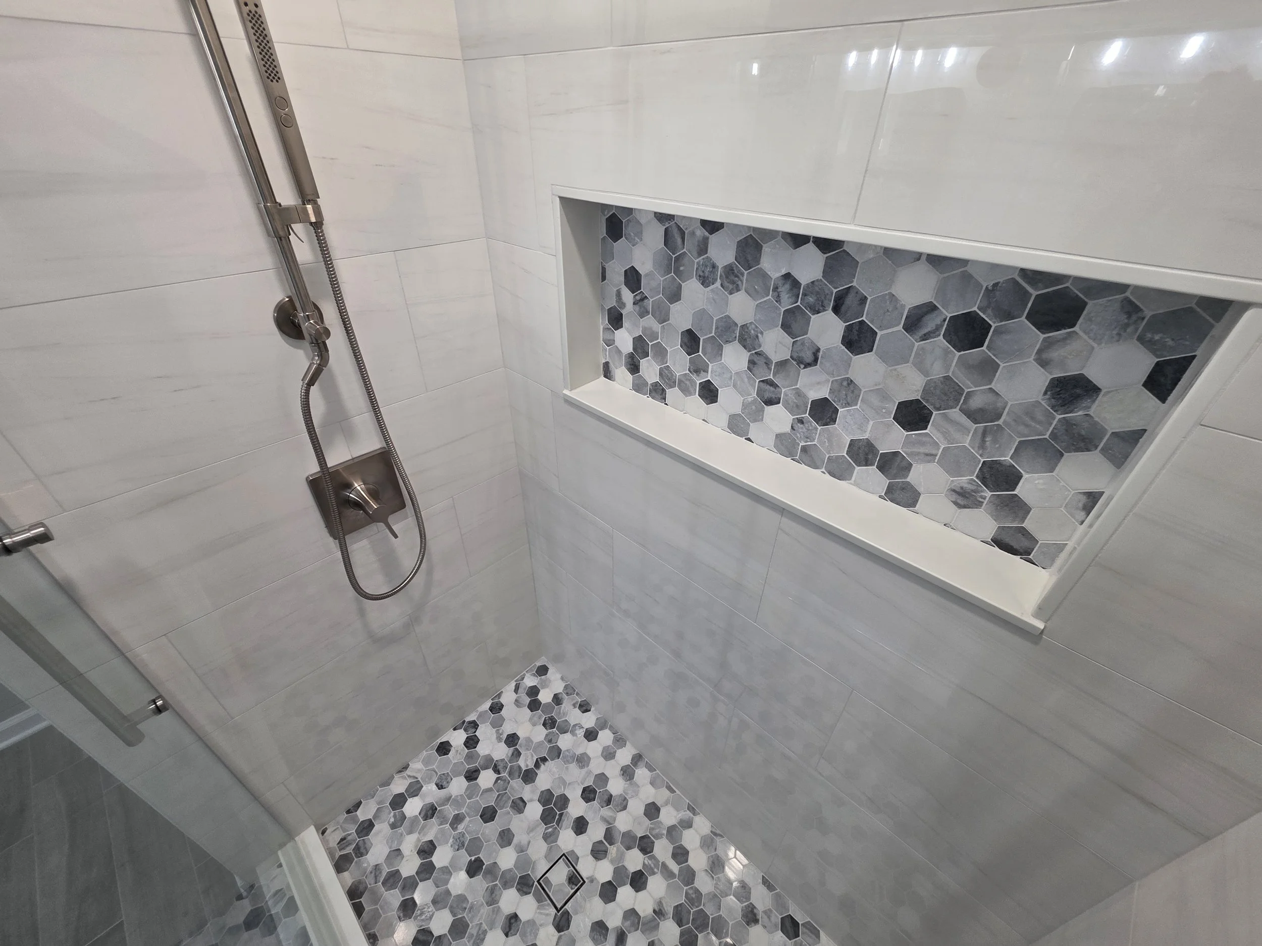 Shower floor and recessed mosaic niche.