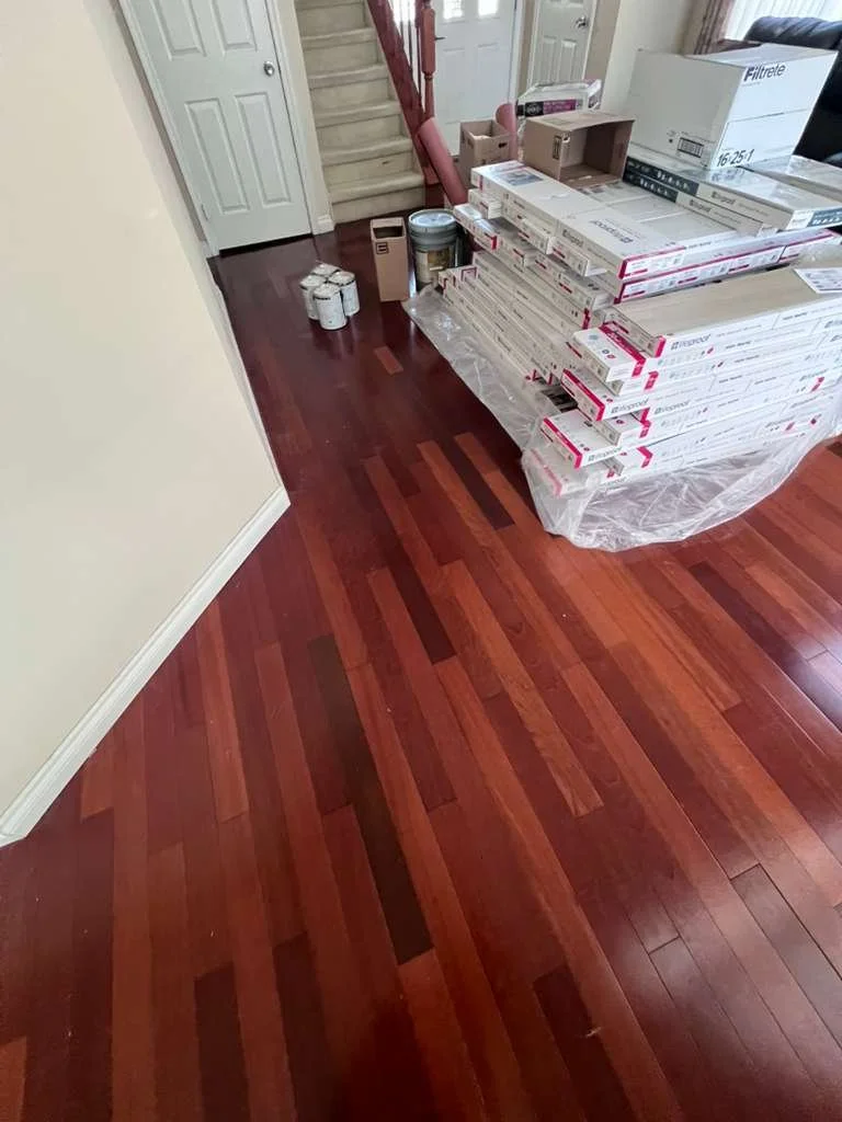 Before renovation: original flooring in the entry area with remodeling materials stacked nearby.