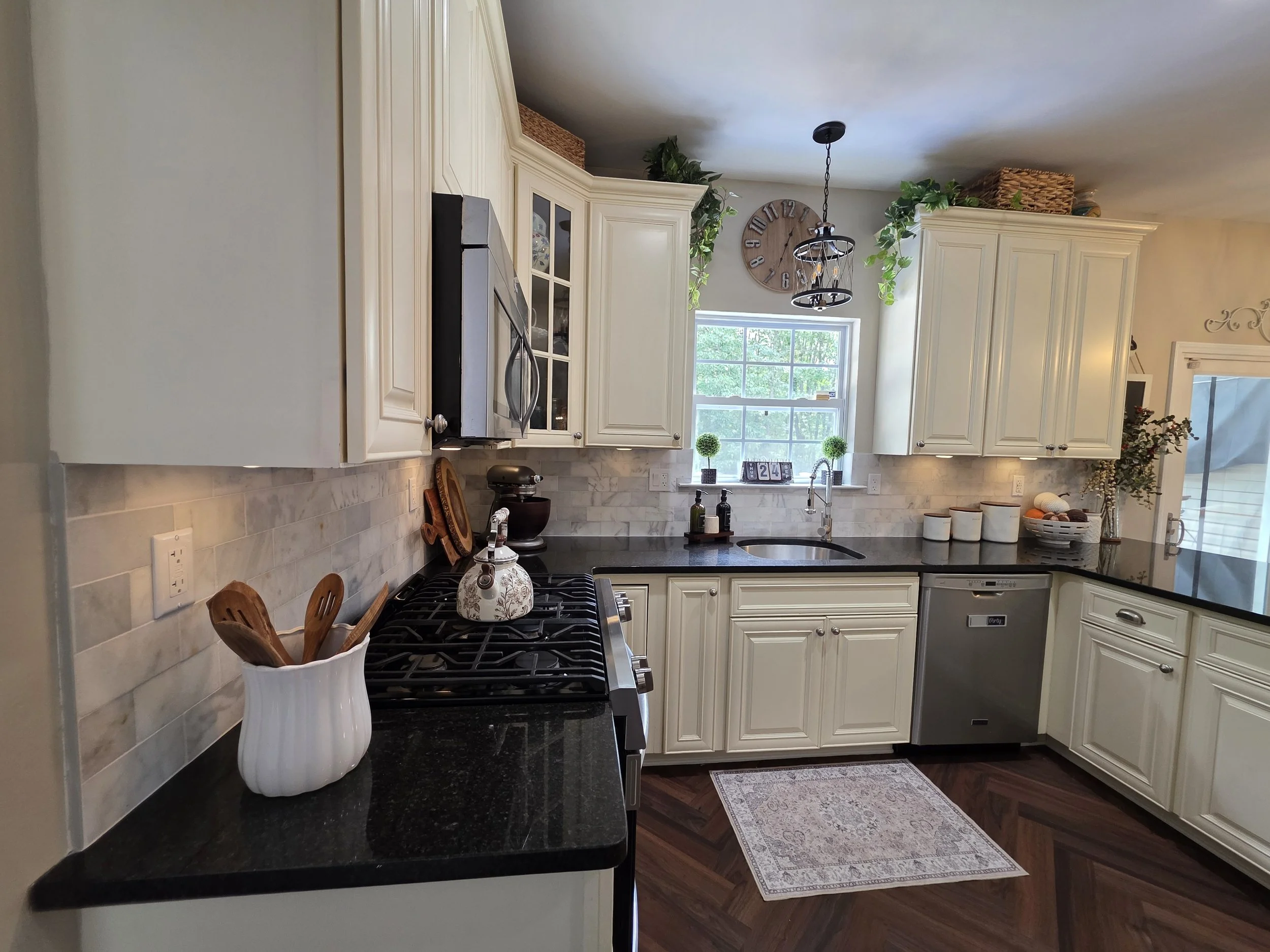 Light backsplash tile along existing dark countertops.
