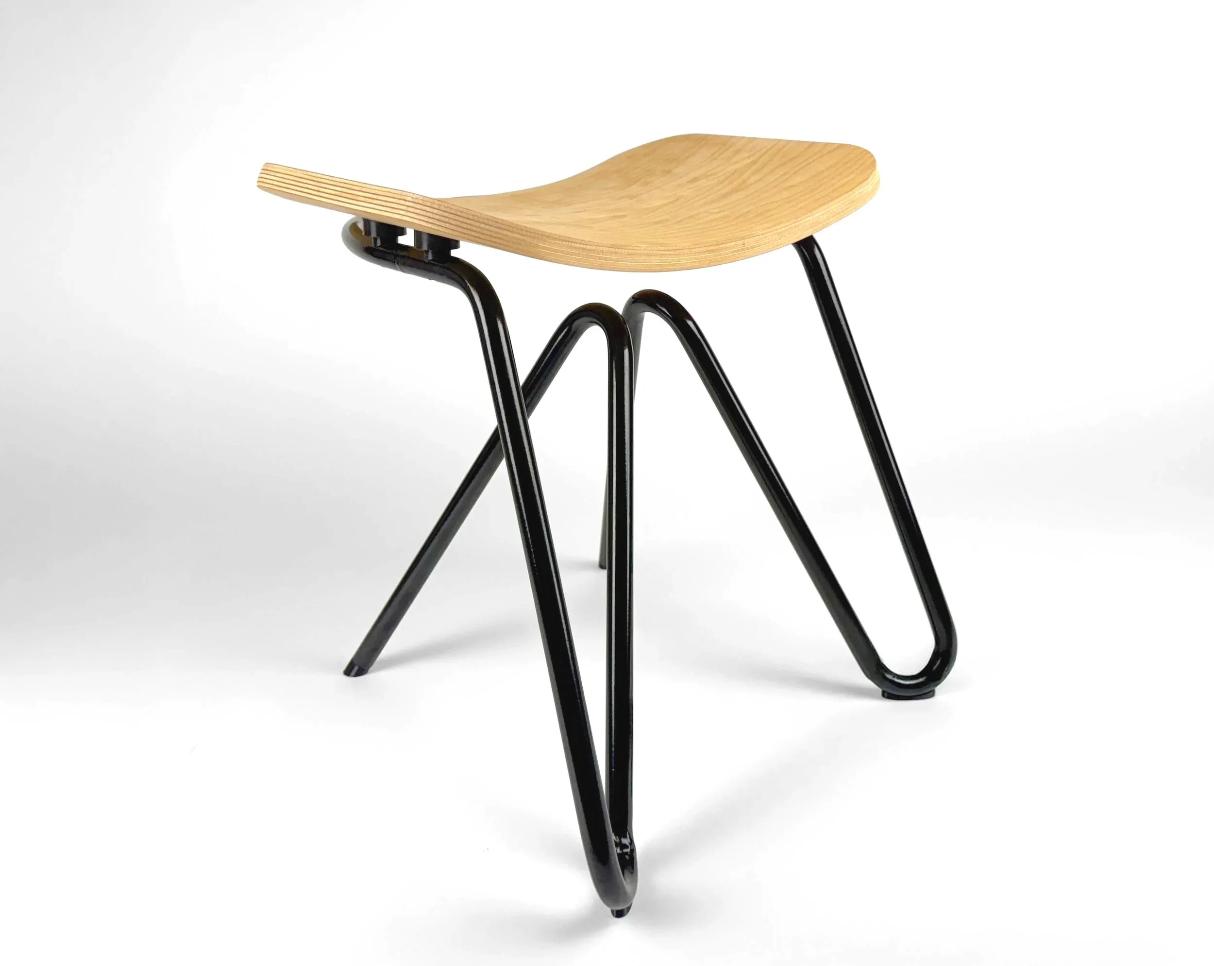 Wooden stool with black metal legs and a curved seat
