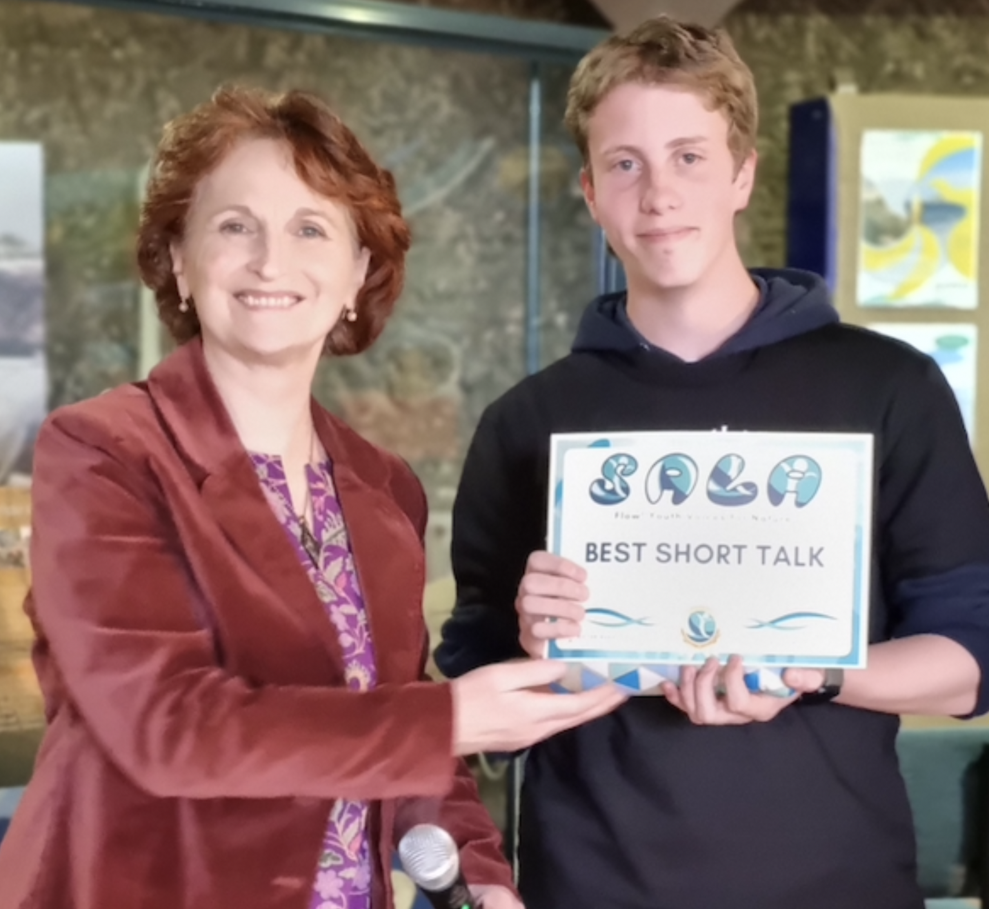 Celeste Hill presenting a prize for best short talk at the 2025 student SALA launch event. 