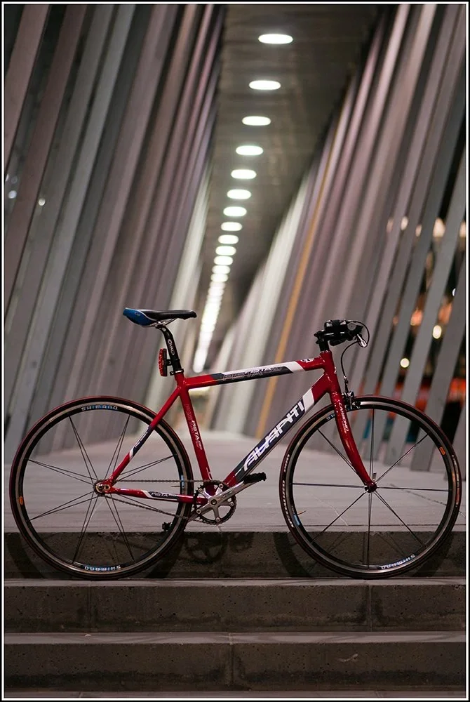Red racing bike in a city arcade — eSquared Melbourne career coaching