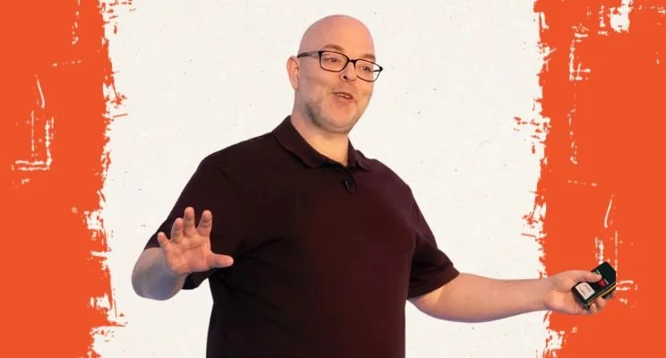 ADHD-ish blog, Phil Drinkwater in black shirt gesturing with hands expressively, How Neurodivergent Shame Shapes ADHD Founder Decisions, ADHD brain, adhd founder, neurodivergent shame