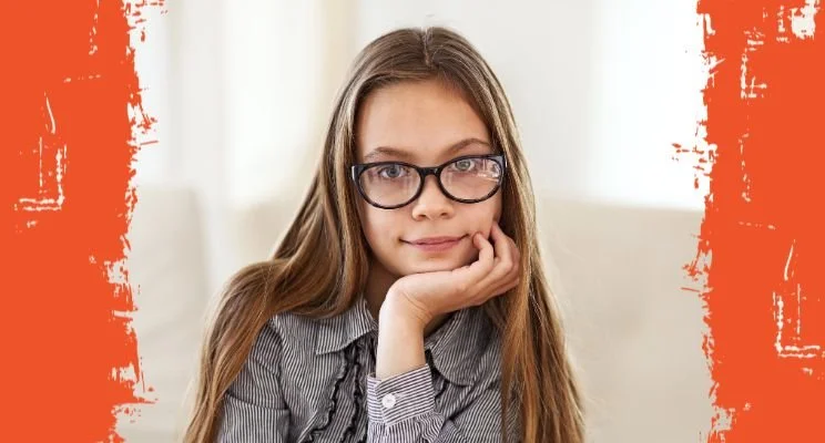 ADHD-ish blog, Young girl with glasses in striped shirt, looking thoughtful, How ADHD Gender Bias Leads to Delayed Diagnosis, adhd strengths and struggles, adhd diagnosis gender bias, adult adhd and delayed diagnosis