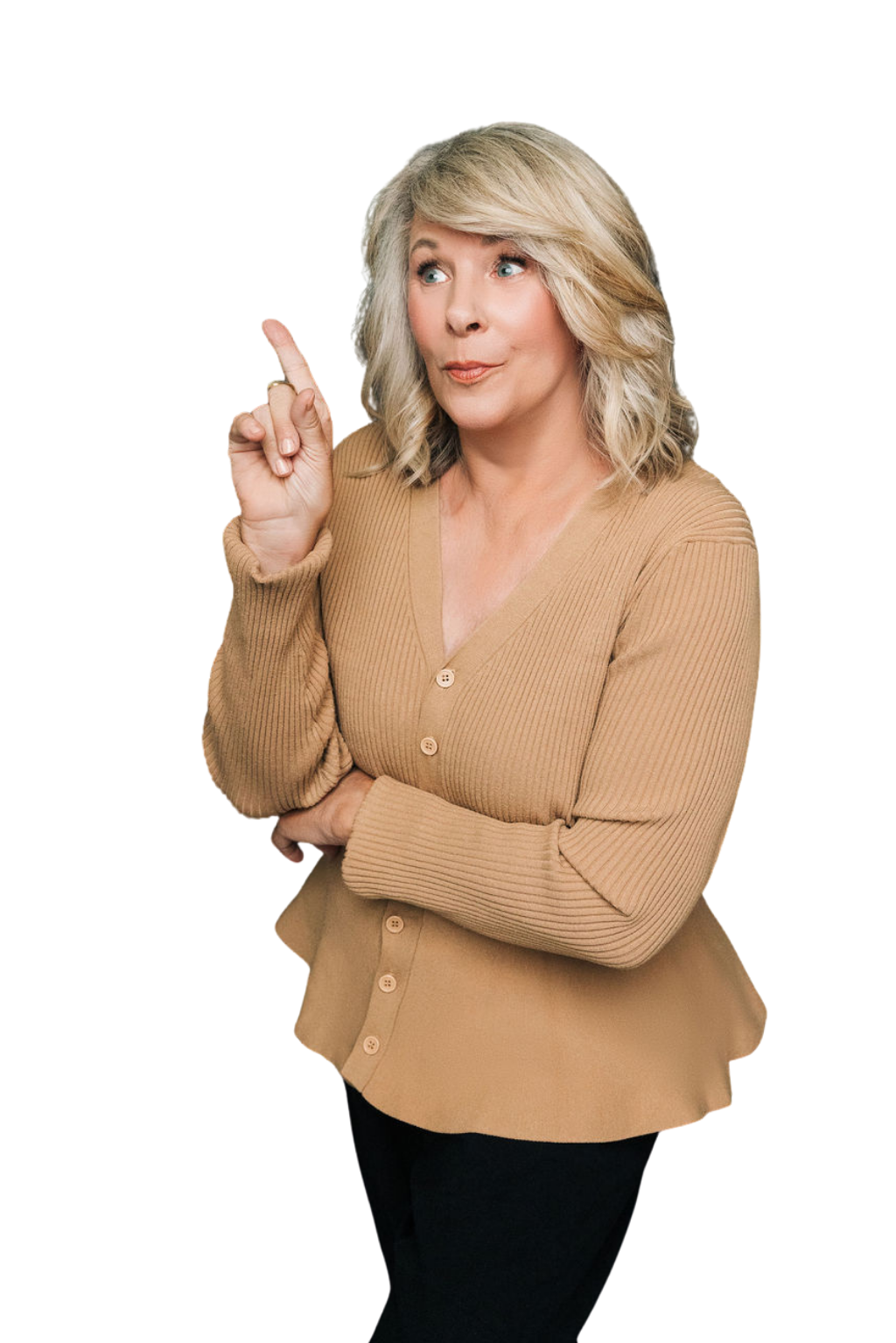 Diann wearing a camel color peplum sweater and black pants pointing toward the text on the page