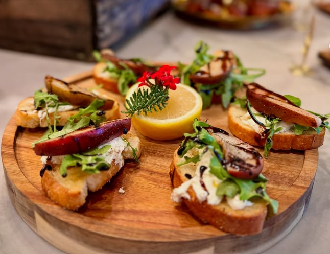 Grilled Pear Bruschetta on a wood board with lemon