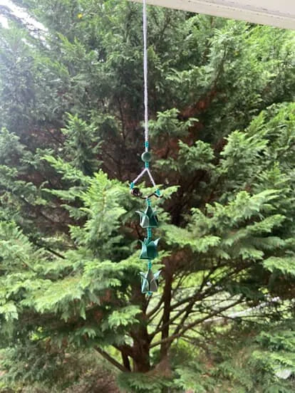 origami mobile hanging in a windowsill