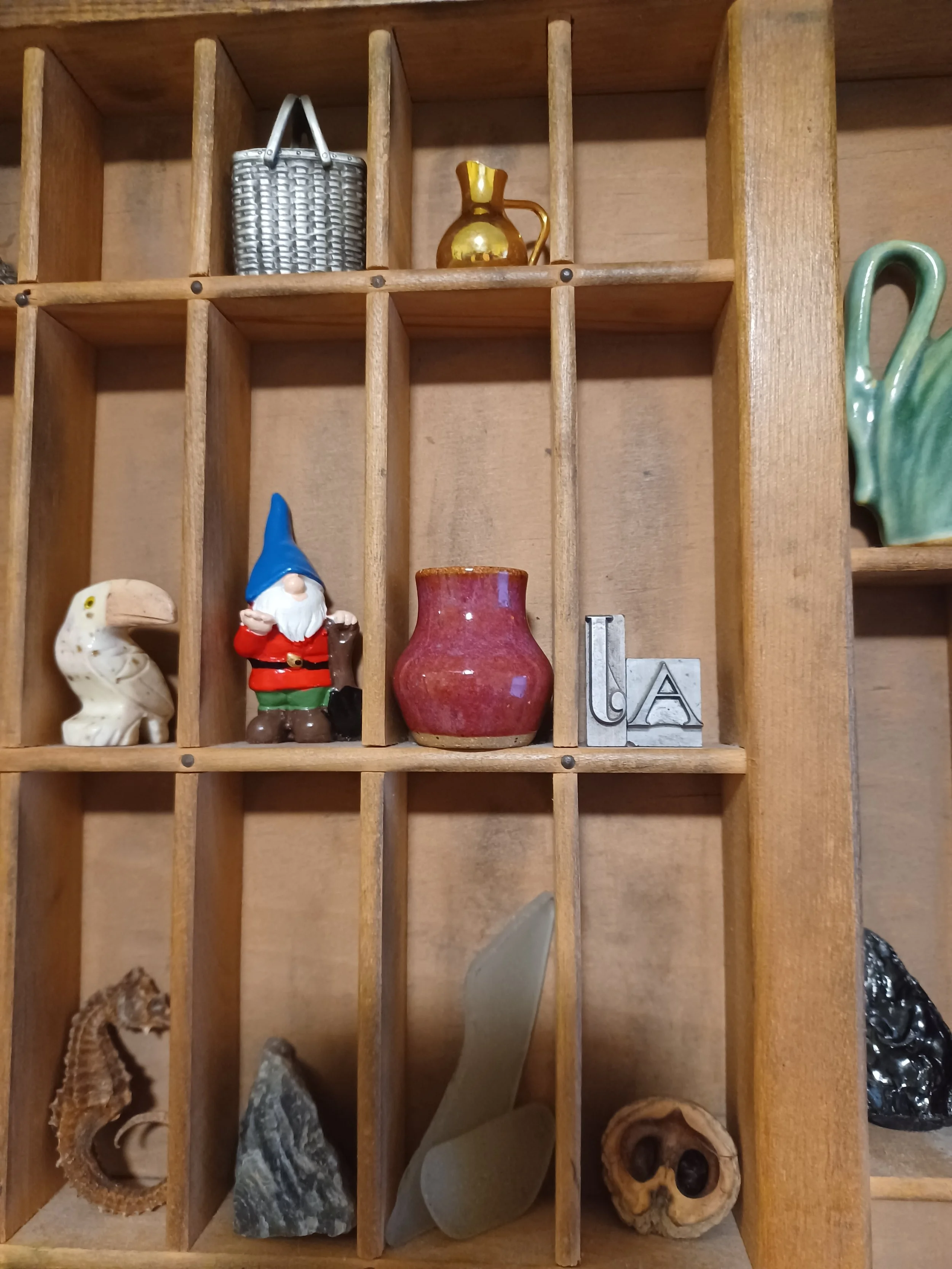 miniature vase pottery by Liza sits on a trinket shelf