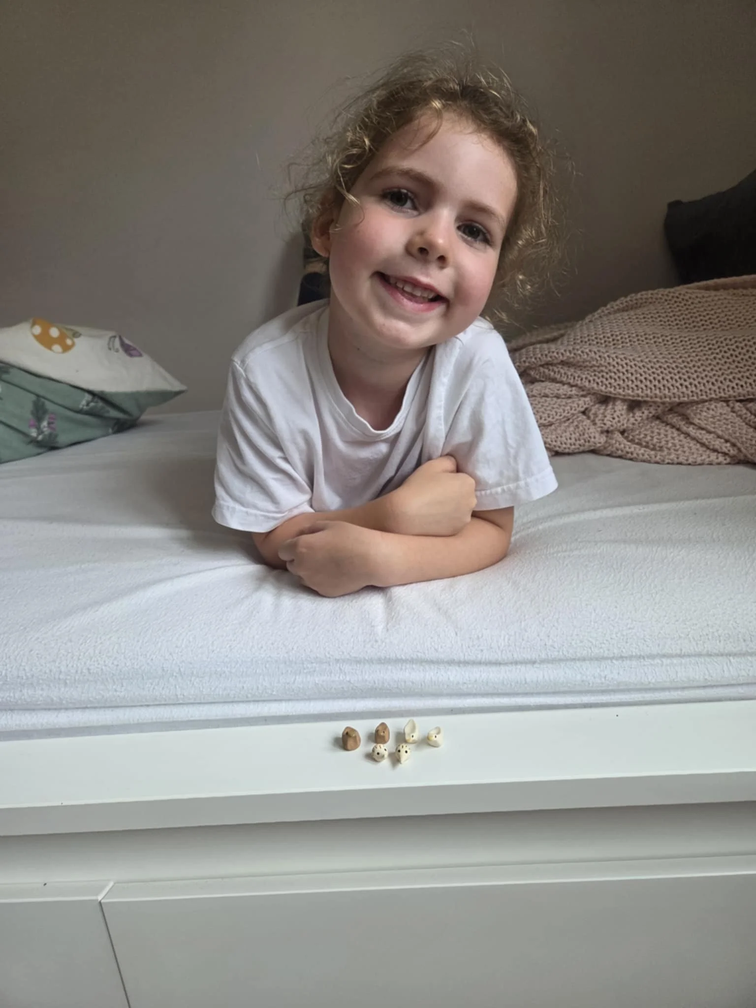 Girl smiles with her miniature hedgehogs and critters pinch pals handmade by Liza in Asheville NC