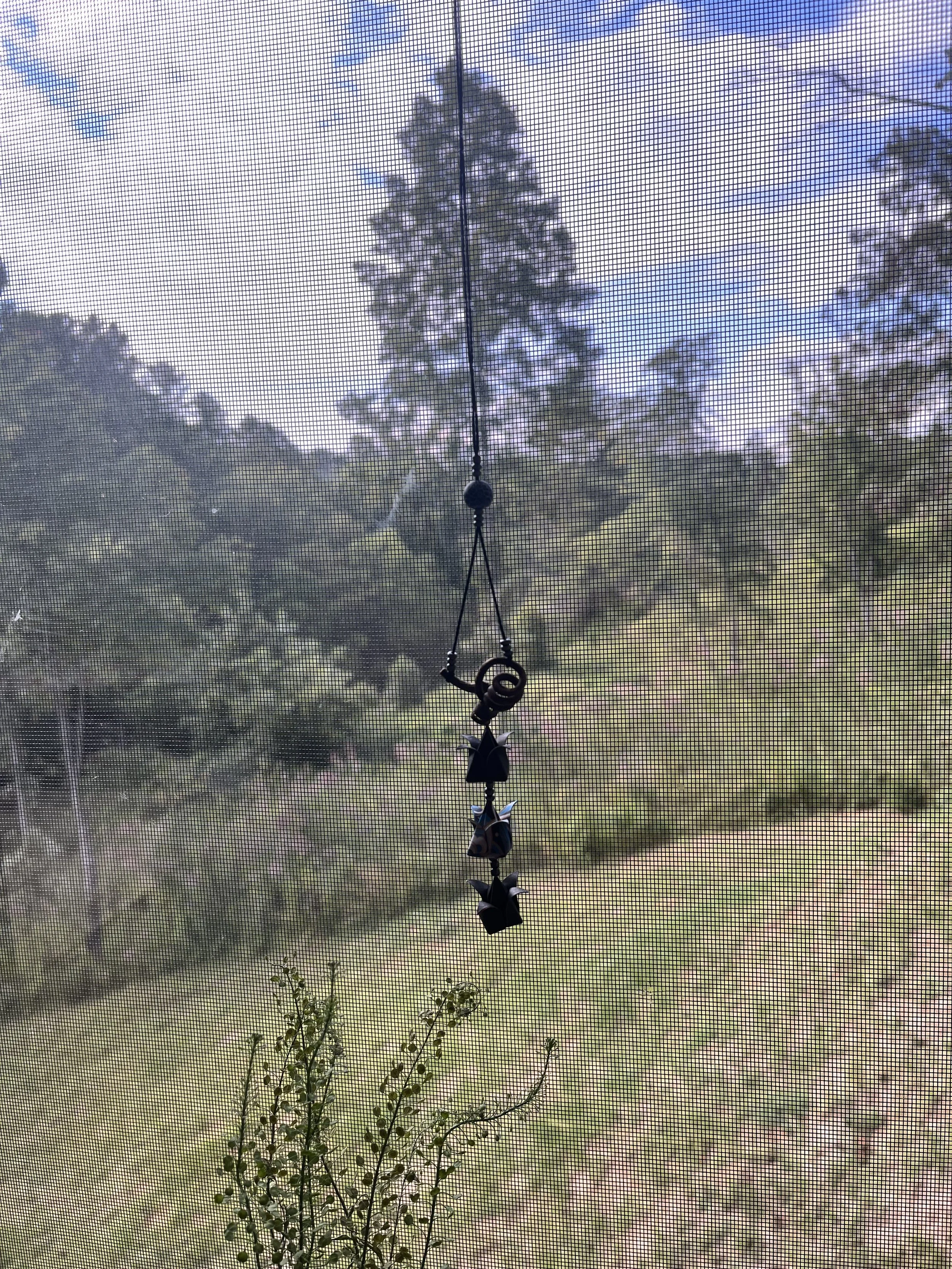 origami mobile hanging in a window