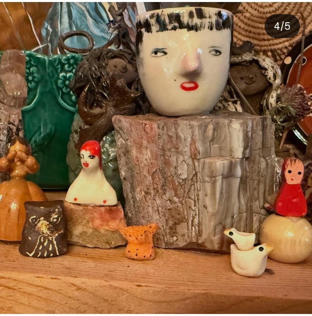 Two miniature ceramic chickens by Liza stacked on top of each other in Asheville NC