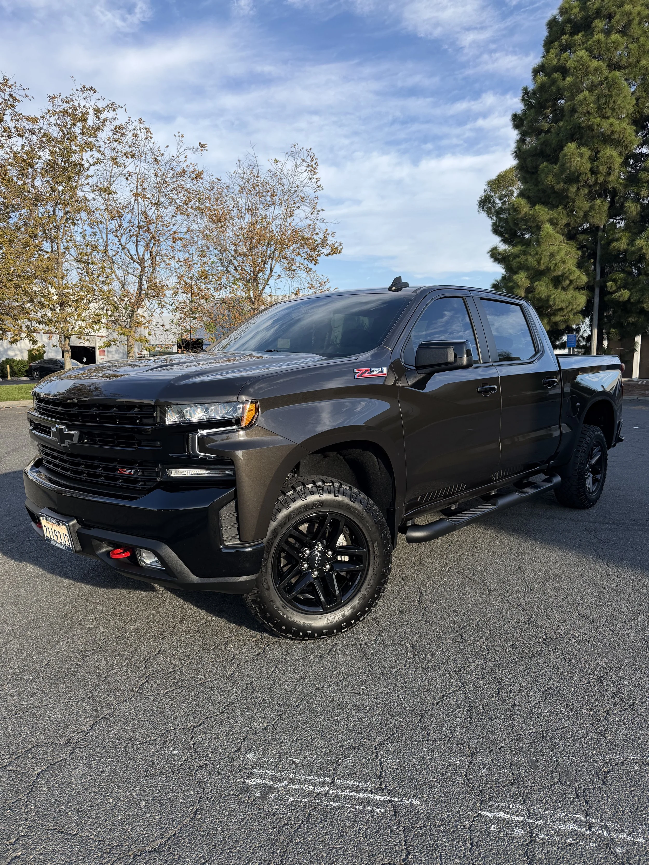 Brown Chevy Silverado being photographed by technician at Protek Automotive Protection. This truck has had ceramic coating applied.