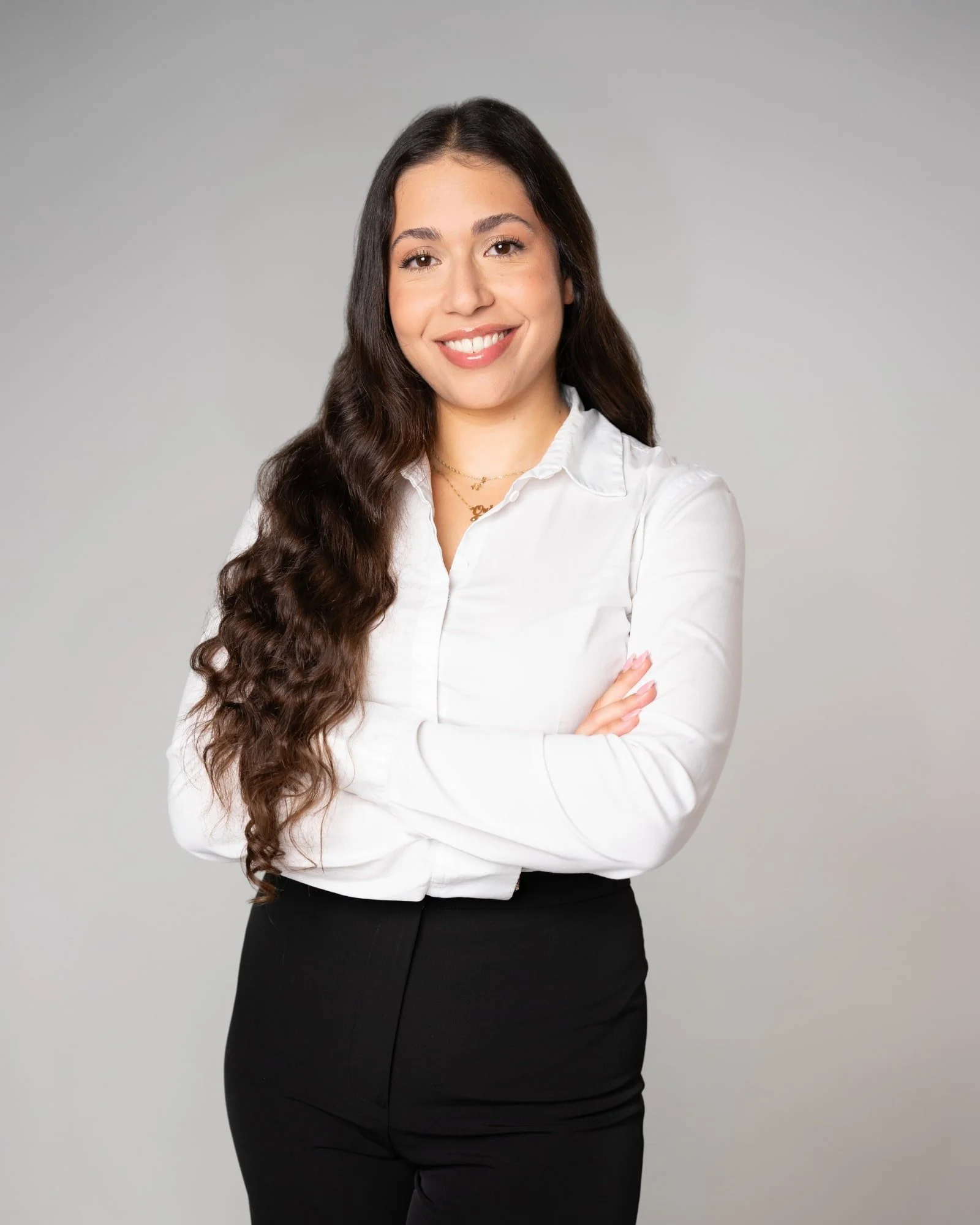 Corporate headshot of a woman in business-casual attire, photographed in studio for a company website