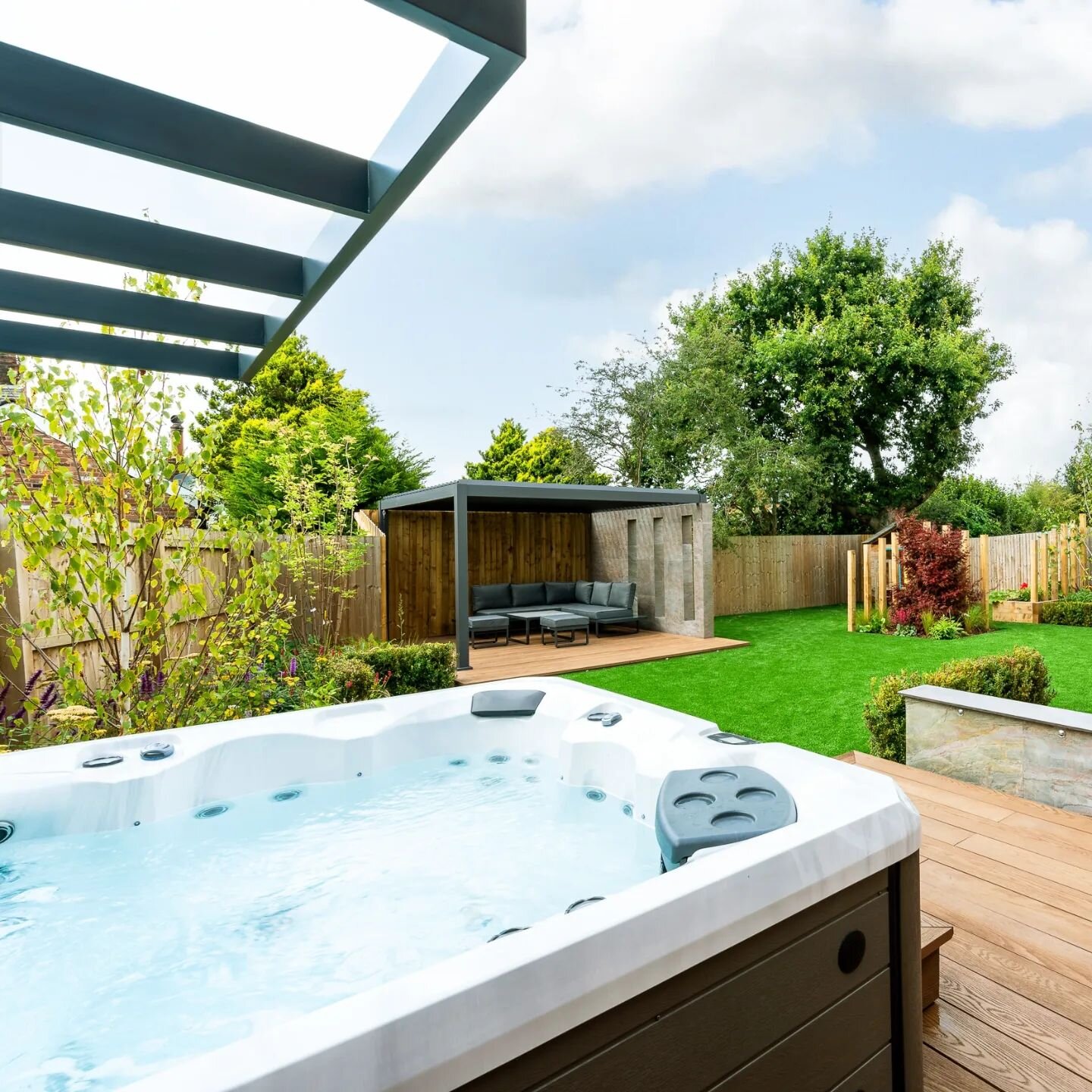 A look back at a job from a project last yea!)r!

A typical new build garden that we designed to be a family orientated space. Firepit, outdoor kitchen, hot tub, peegola, play area, lawn, the Client wanted it all and we used angles for added interest